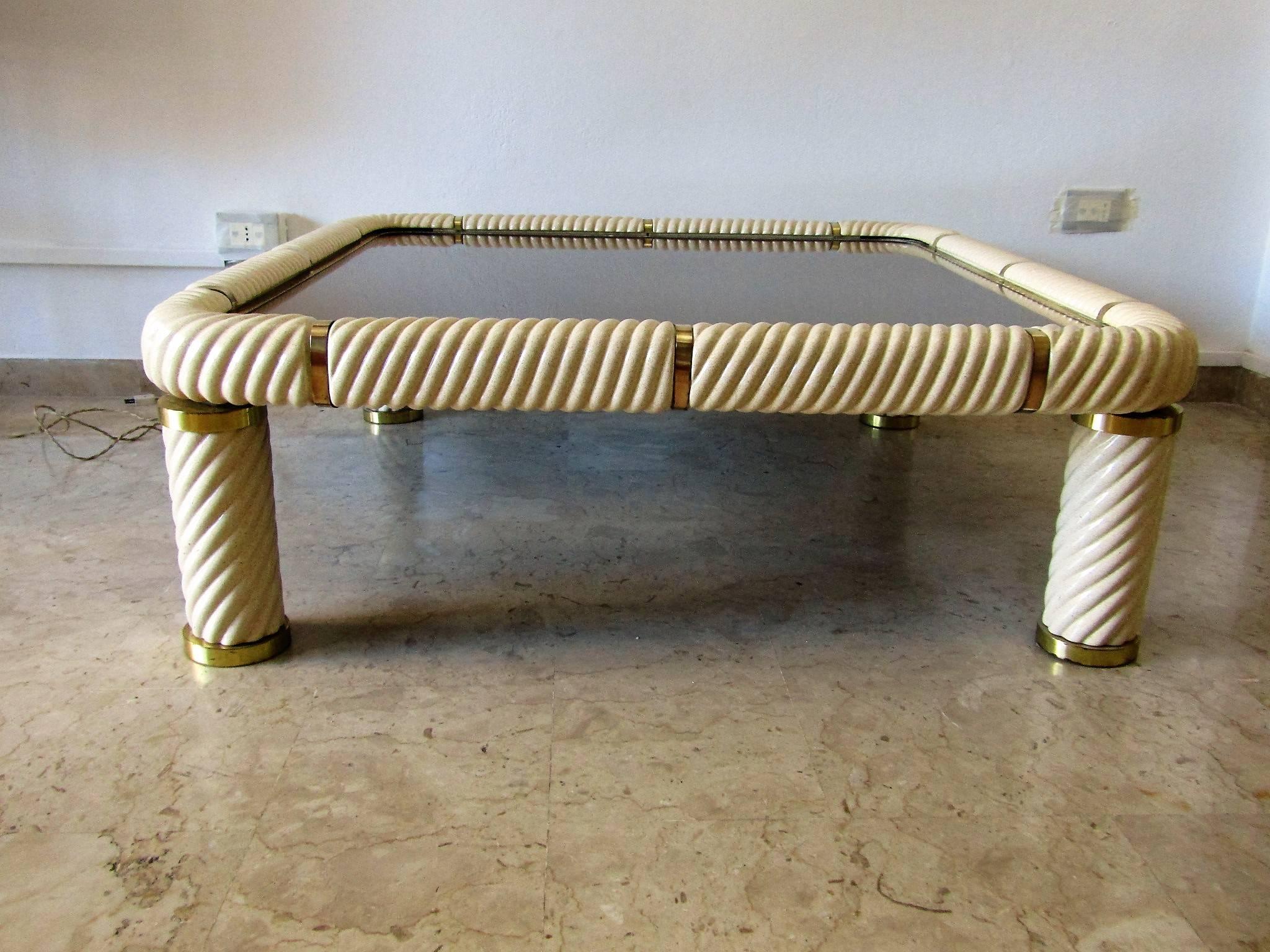 Table coffee by Tommaso Barbi realizzed in ceramics and brass. In the Hollywood Regency style.
This remarkable piece has legs spiraling column porcelain shape and top with decorative solid brass supports throughout. The glass insert gray glass