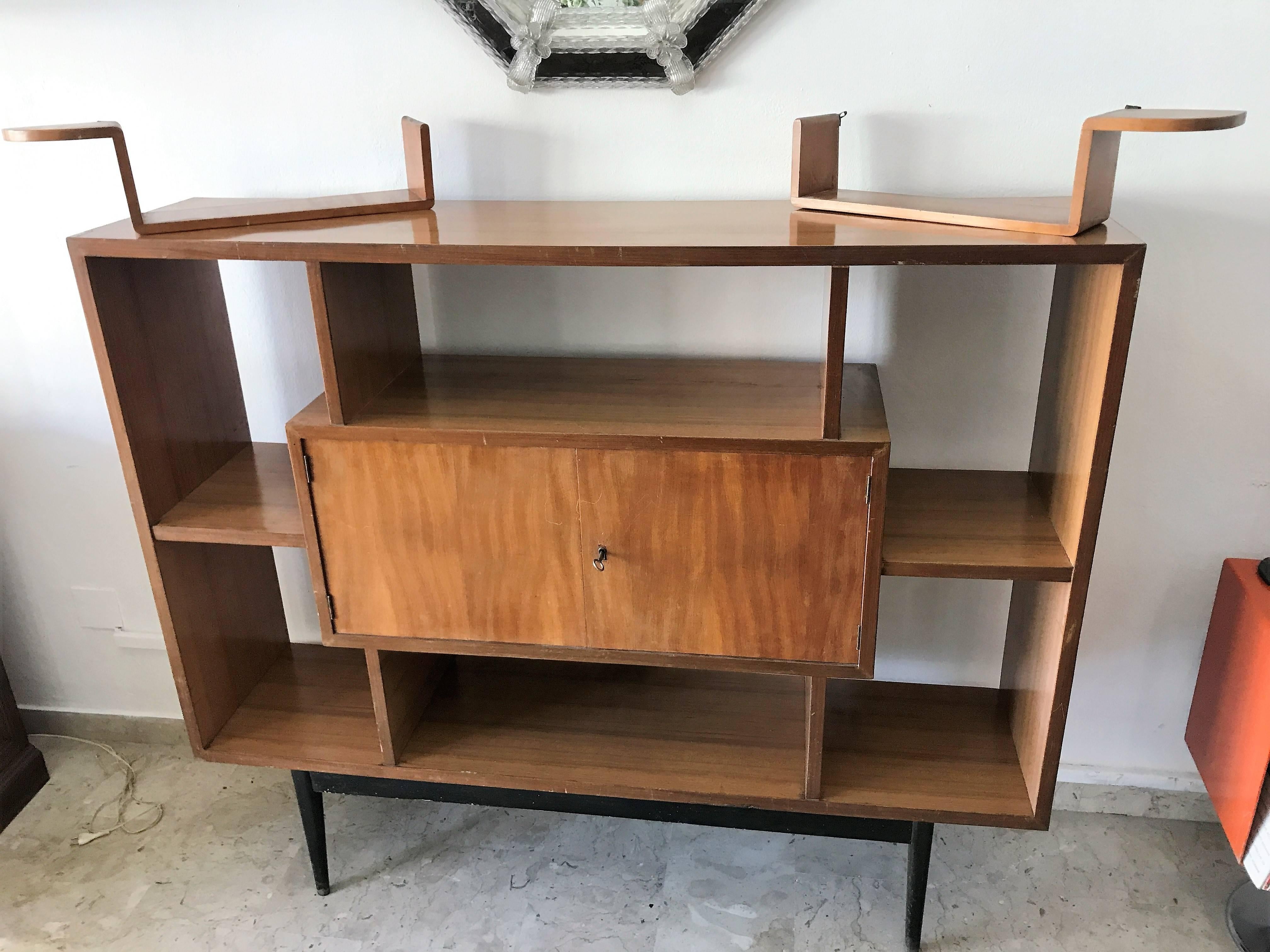 Modern teak bookcase with seven shelves and one small closet. A piece with a unique style. Created in Denmark in about 1960.