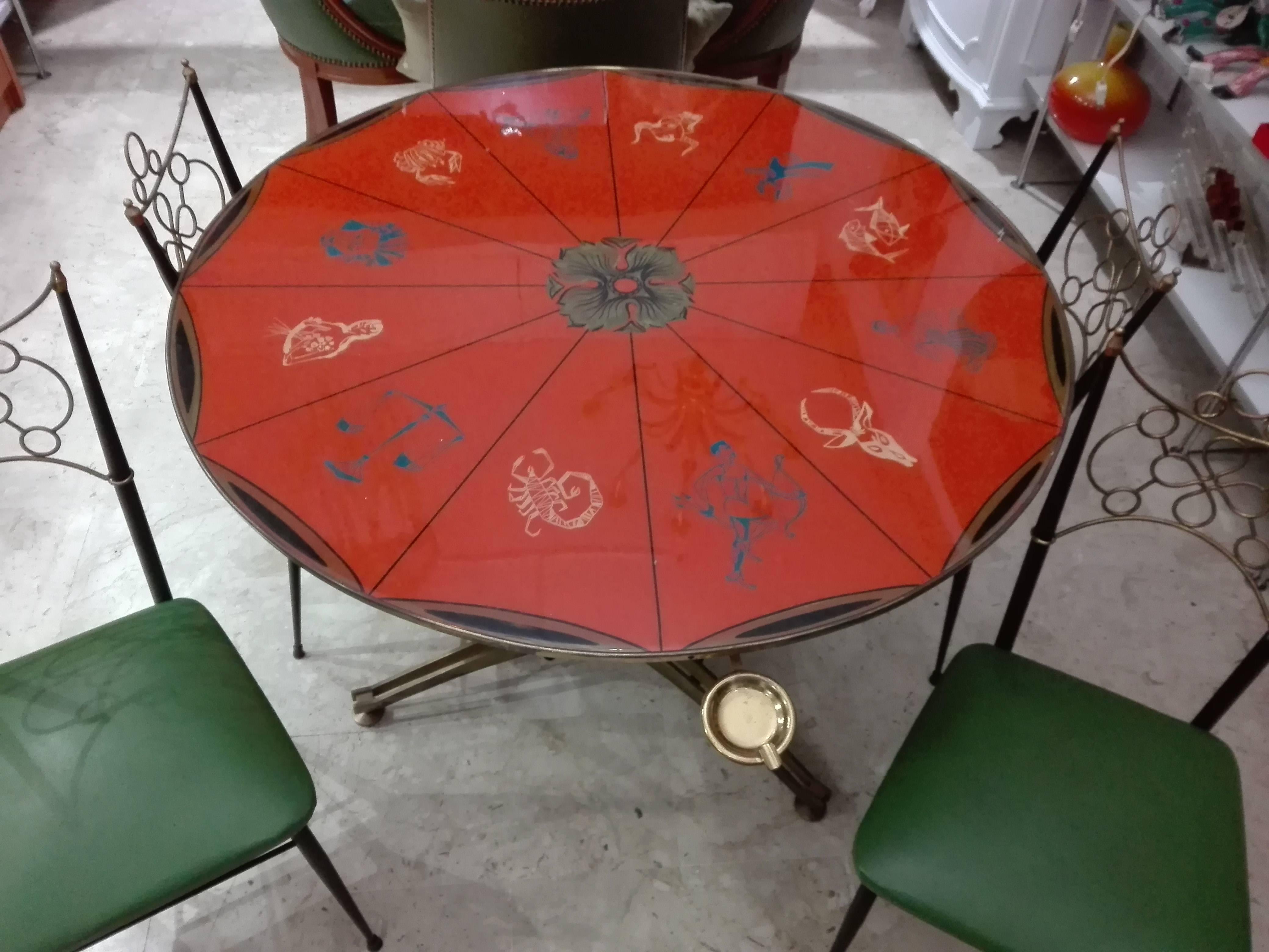 Exceptional round coffee table/game 50 years plan with zodiac signs
Brass feet adjustable in height
Measures: diameter of the top 100 cm, height 79 cm
Set of four chairs from the 1950s.
Handicraft production - structure in painted metal and
