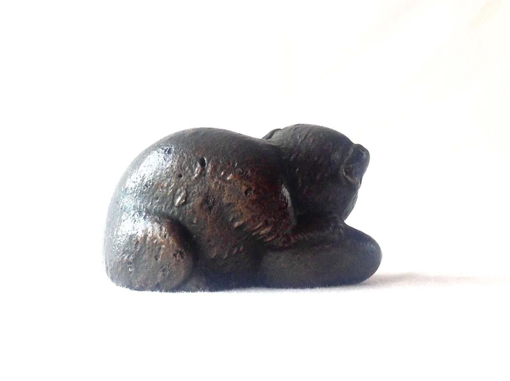 Signed Tiffany Studios/New York bronze figure paperweight, original patina, measures 1.5 inches high and 2.5 inches wide.