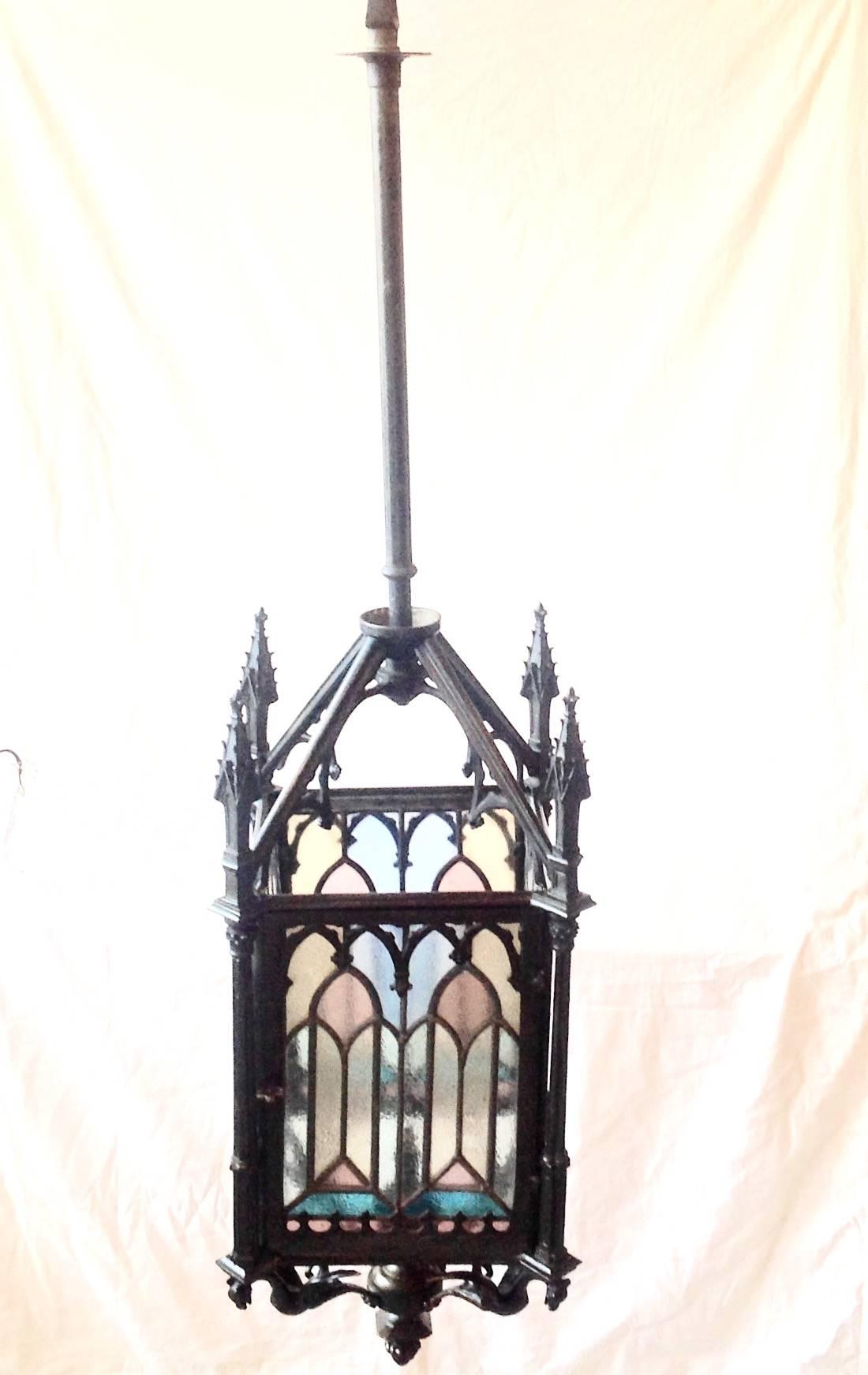 Beautiful and unusual antique French bronze and stained glass Gas Gothic lantern. Late 1800s, antique patina, measure 12 inches wide and 43 inches high. Hangs on rod.