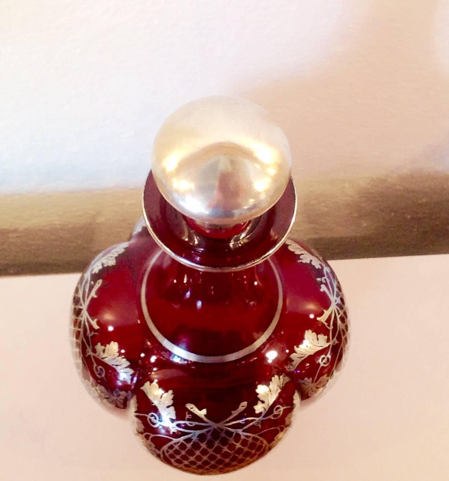 Early 1900s Art Nouveau ruby crystal/glass decanter with silver overlay and sterling silver stopper. Stopper has 