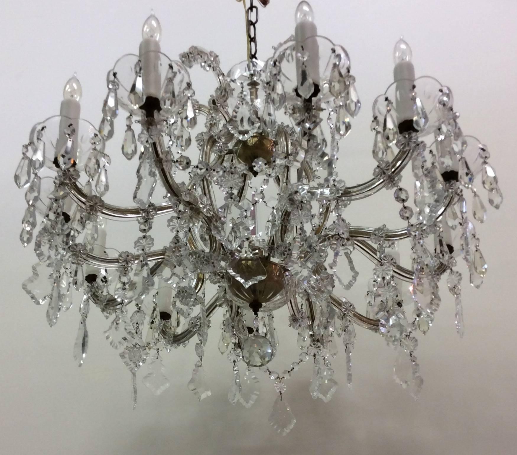 Maria Theresa crystal chandelier with twelve Lights, circa 1920. Excellent quality Czechoslovakian crystal prisms. Gold leaf iron frame. Restored and wired to UL standards. Measures 29 inches wide and 24 inches high.