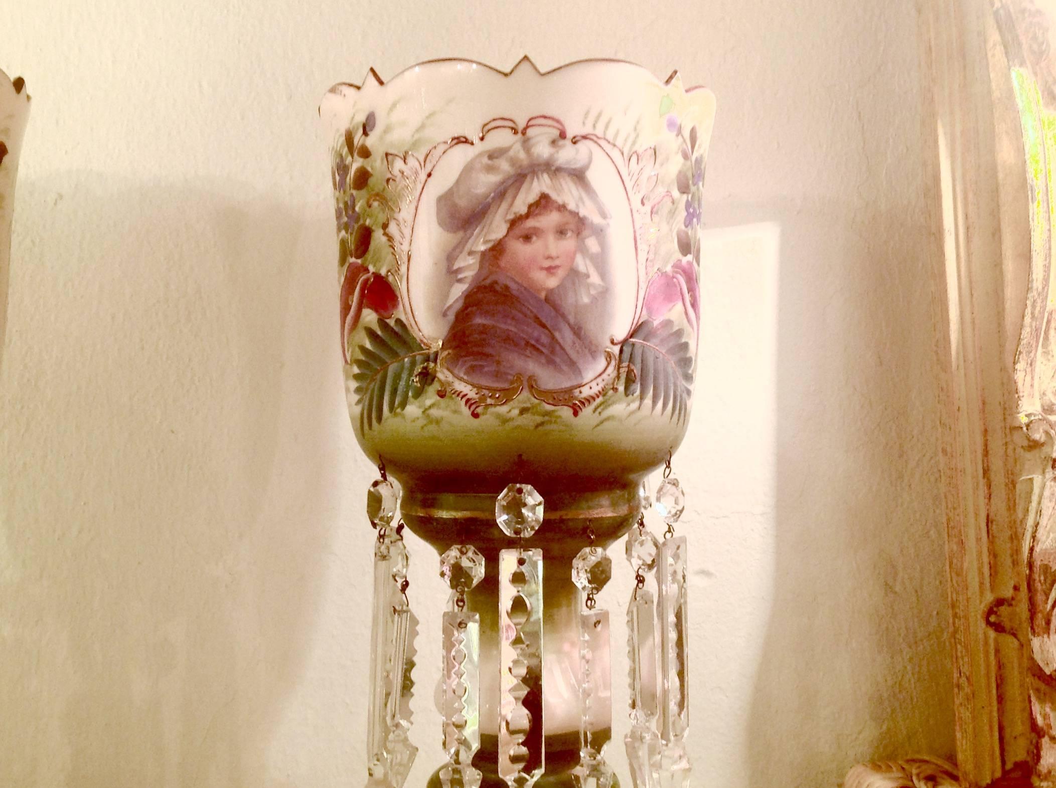 Pair of Victorian hand-painted glass mantel lustre vases, with spear cut prisms, circa 1880. Two different portraits on either side, measure 15 inches high and 7 inches in diameter.