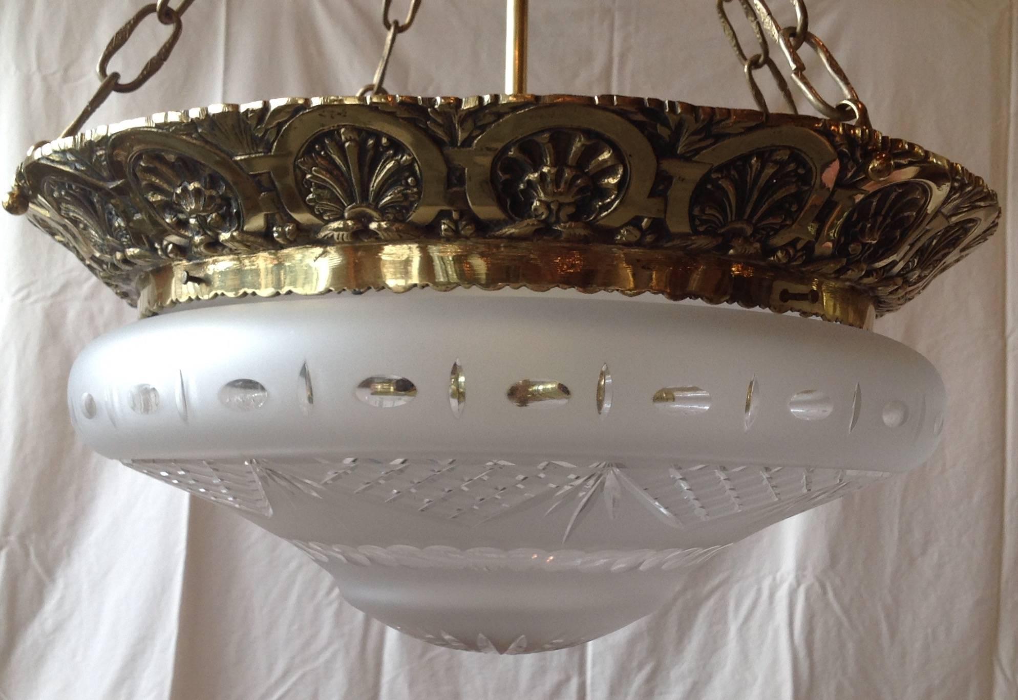 Pair of American 1920s, cast brass and cut crystal, glass frosted bowl/globe bottom. Measure 24 inches high and 21 inches in diameter. 16" shade fitter. These can be adjusted to ceiling heights, hang from chain and canopy. Good for a foyer