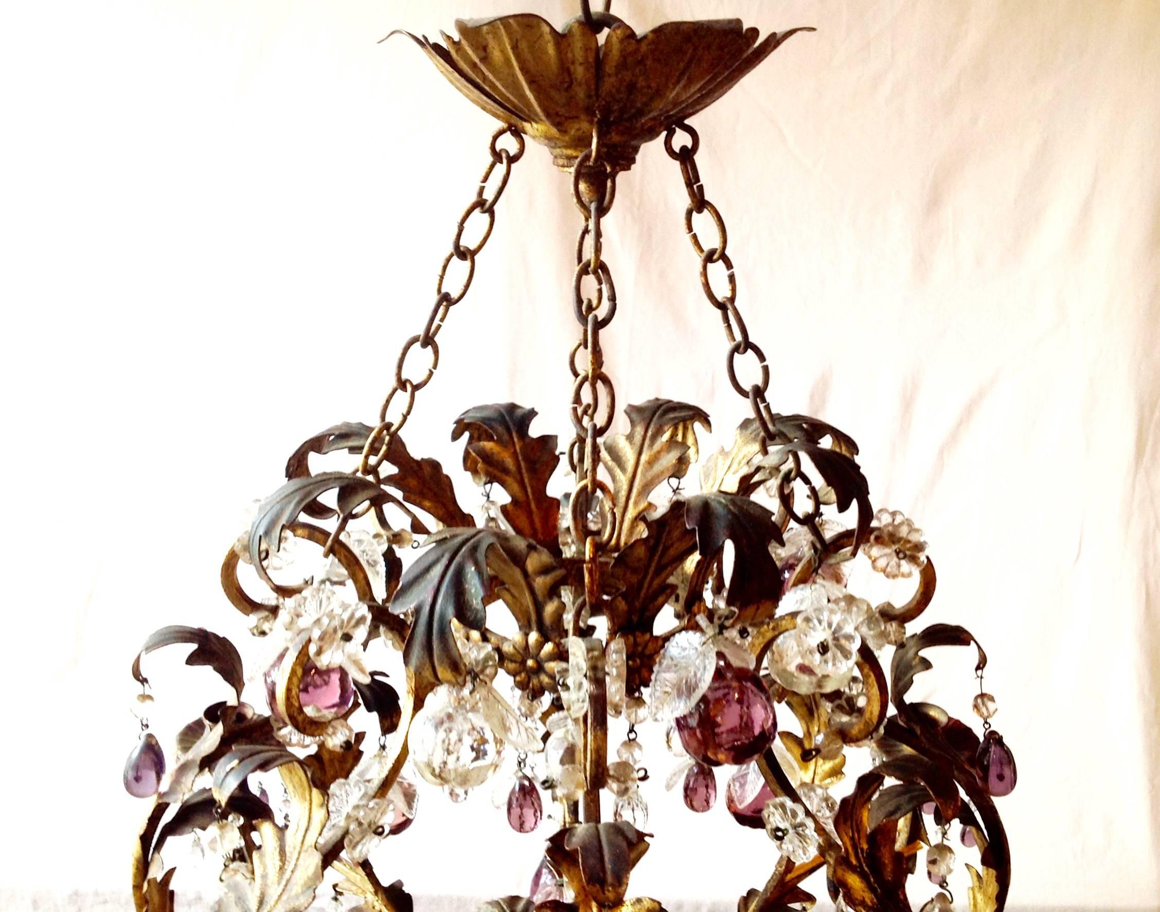 Antique Italian gold leaf tole chandelier, circa 1920. Excellent quality purple and clear fruit shaped crystals. Measures 26 by 26.