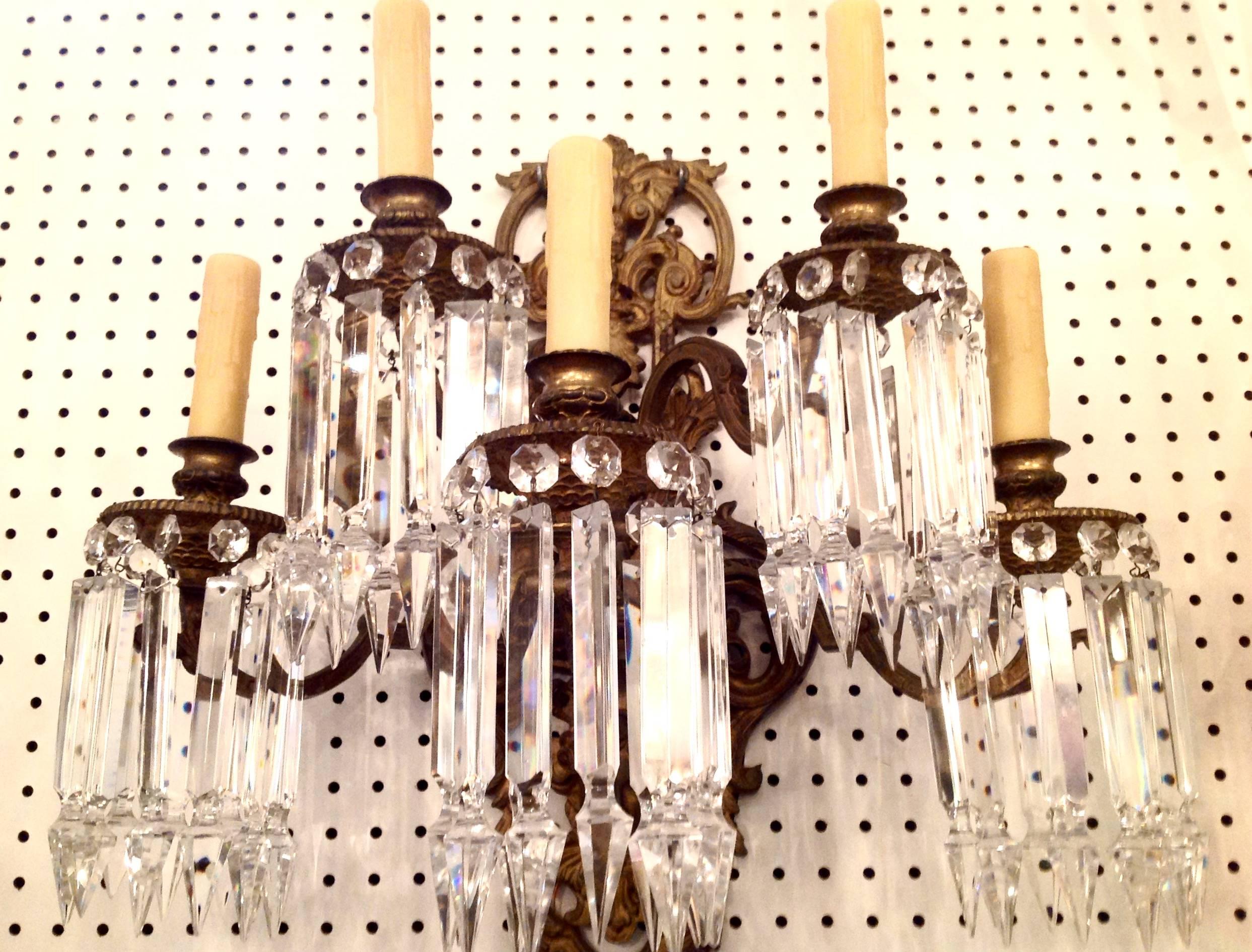 Pair of Grande Victorian bronze wall sconces, circa 1920. Over the top cut spear crystal prisms. Measure 22 inches wide by 22 inches high. Have been restored and rewired to UL standards.