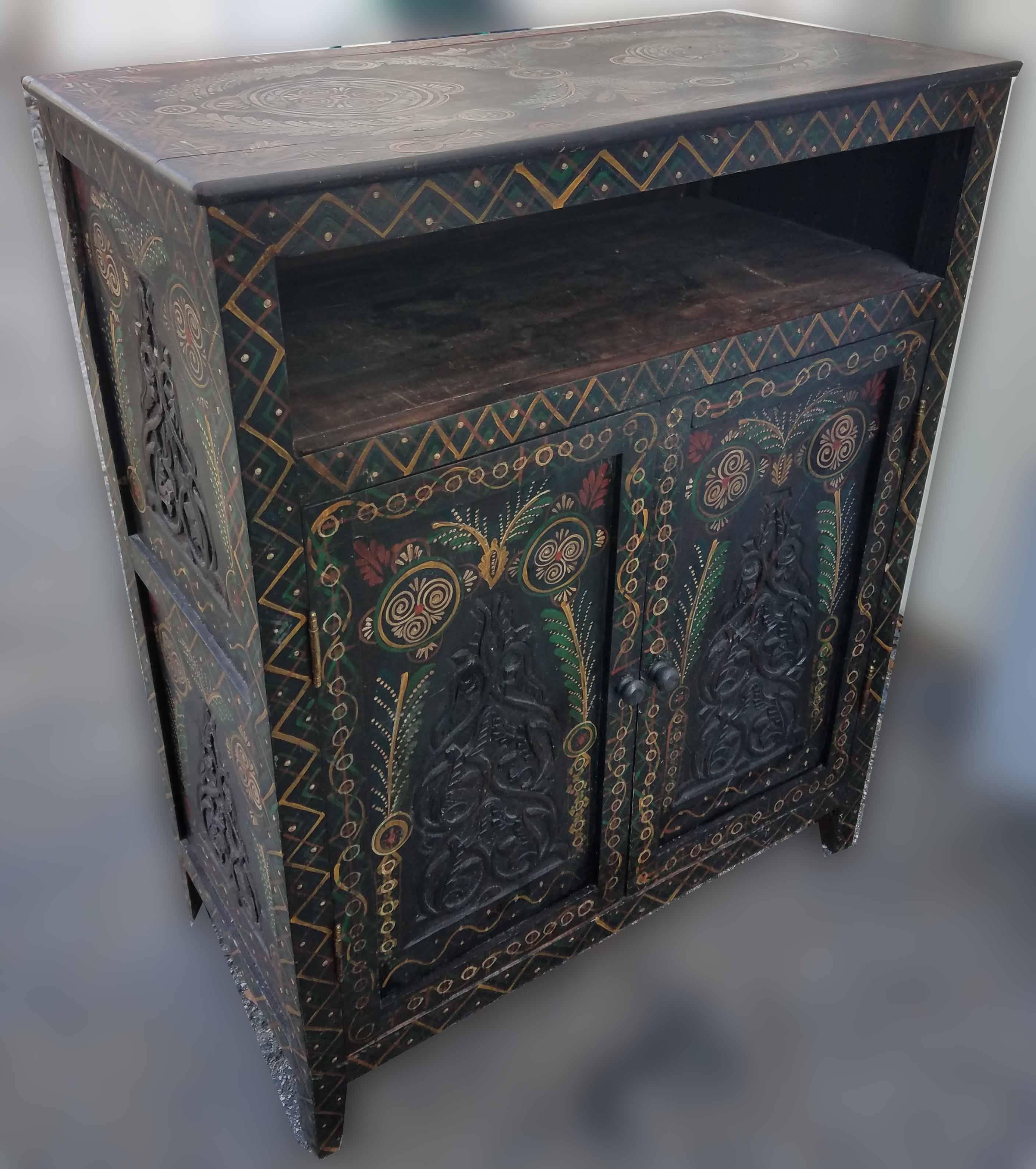 Aged brown handmade Moroccan cedar wooden cabinet measuring 38” in height, 30” in width, and 16” in depth, and featuring two inside shelves with double doors and one open shelf above. Plenty of storage. Lots of carvings throughout. Can work as a