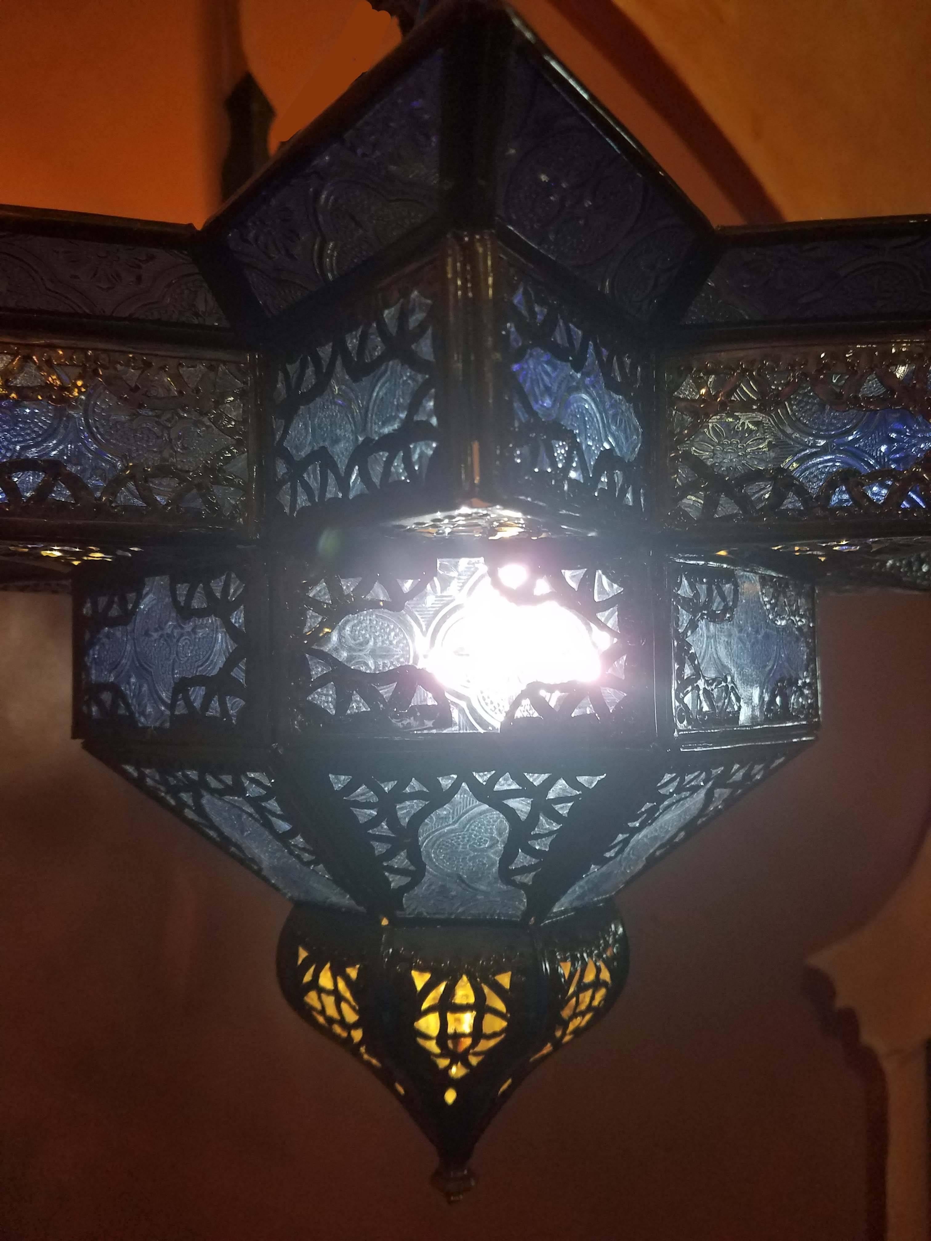 Small size Moroccan glass / metal lantern, star shape with blue color glass throughout on a aged stained frame, measuring approximately 11