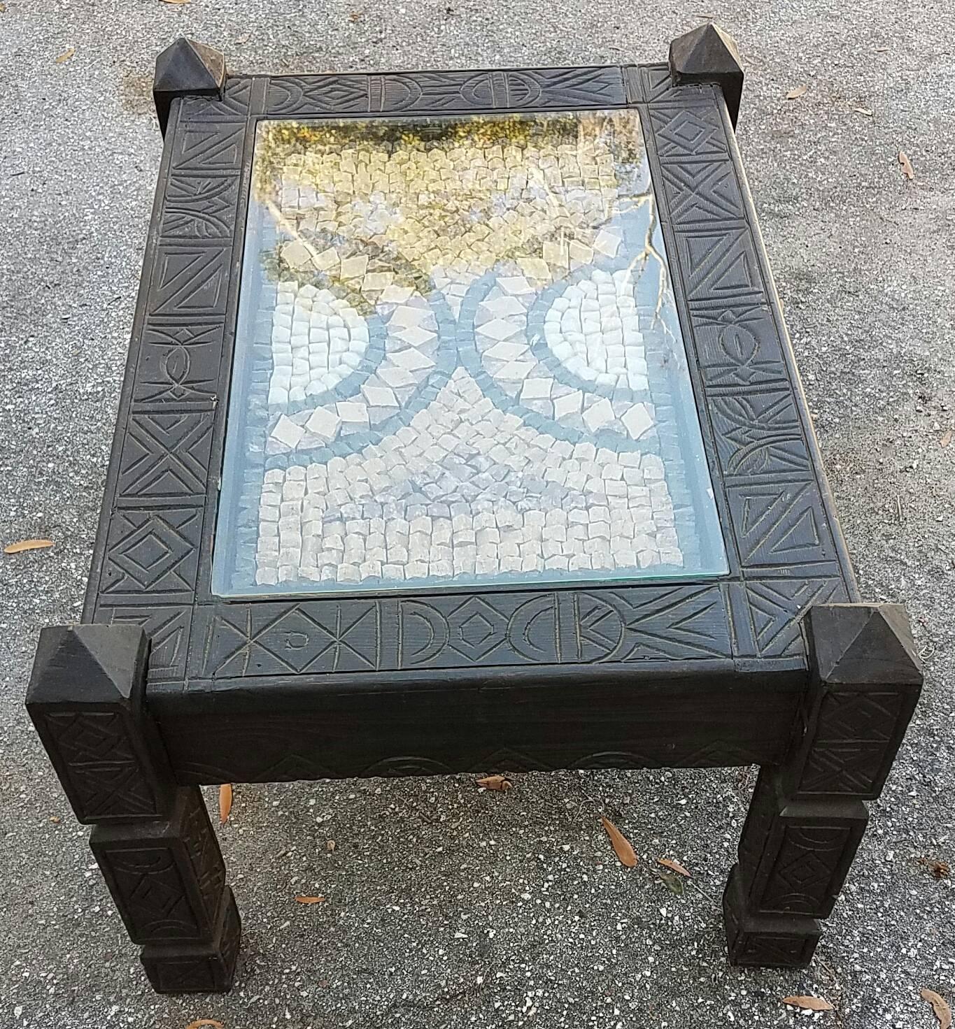 Hand-carved wood and inlaid marble tiles coffee table. Moroccan origin. Rectangular shape. This table brings together the art of tile laying along with wood sculpting, both Moroccan traditions. Measures approximately 32” in length and 23” in width.