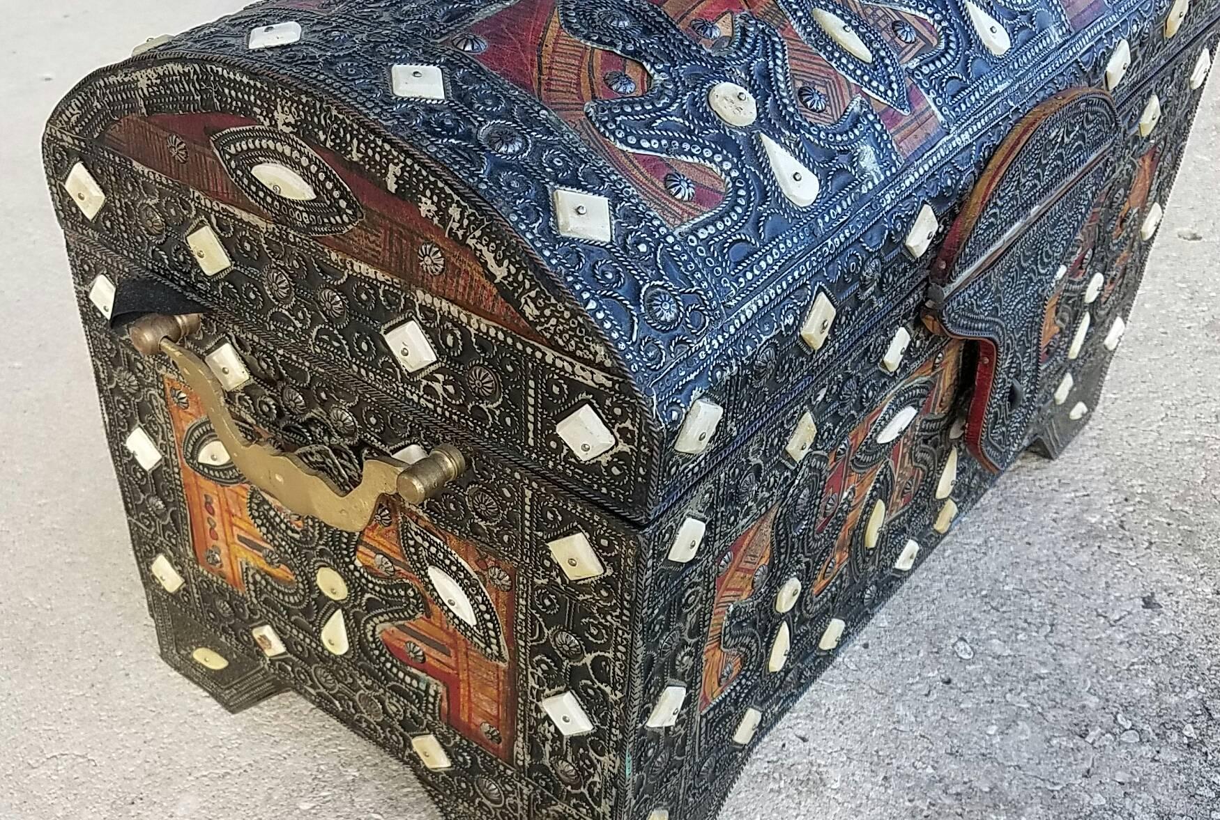 A beautiful Moroccan camel bone trunk from Marrakech. Camel bone dyed in Henna and colorful leather patches mixed with metal inlaid makes this trunk a great addition to any décor. Measuring approximately 21