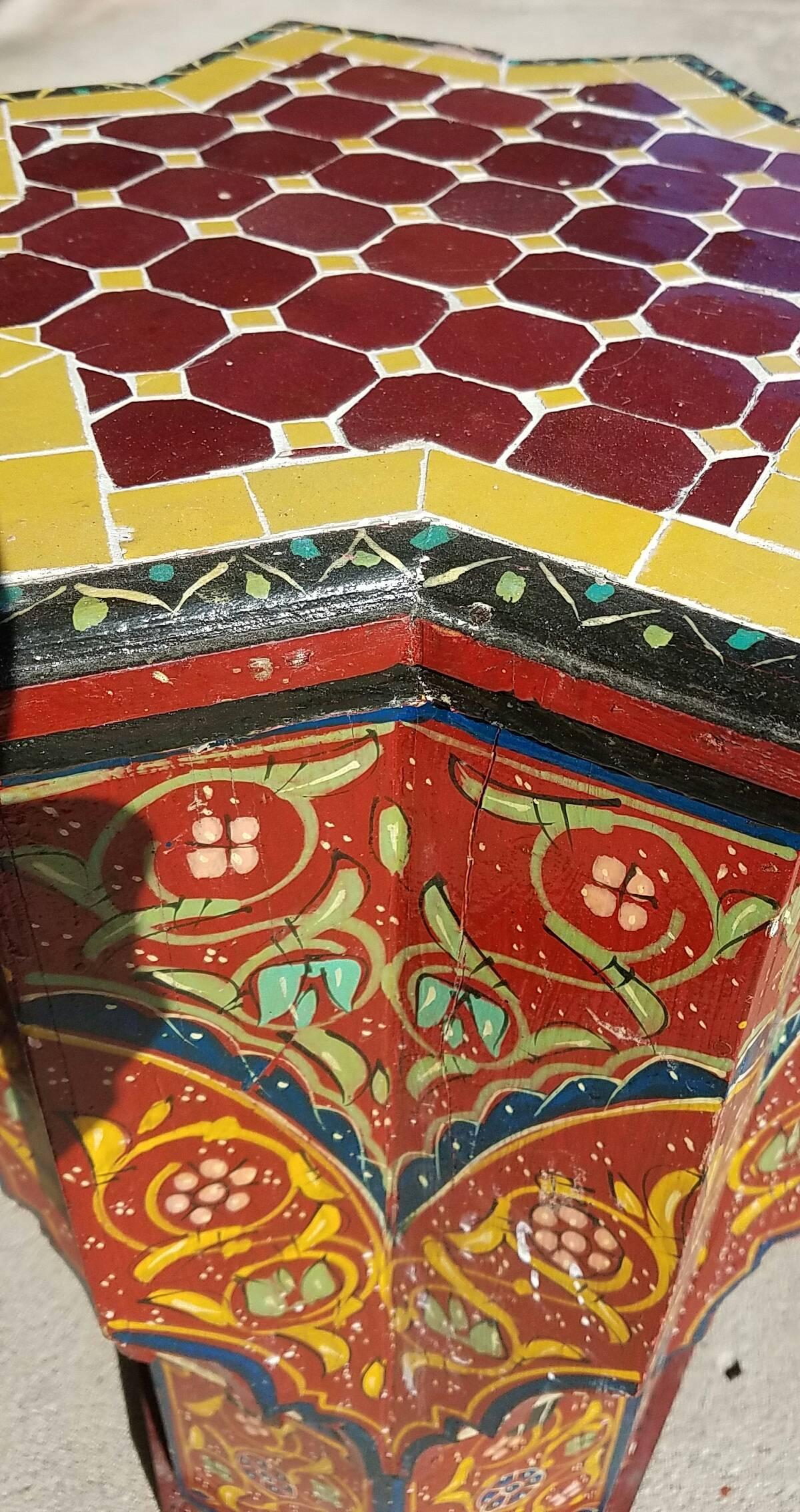 Rare find! Carved and 100% hand-painted Moroccan star shape side table. But this one has beautiful tiles on top, instead of the usual piece of glass. Beautiful add-on to your Décor. This table measures approximately 21″ in height, 16″ in diameter