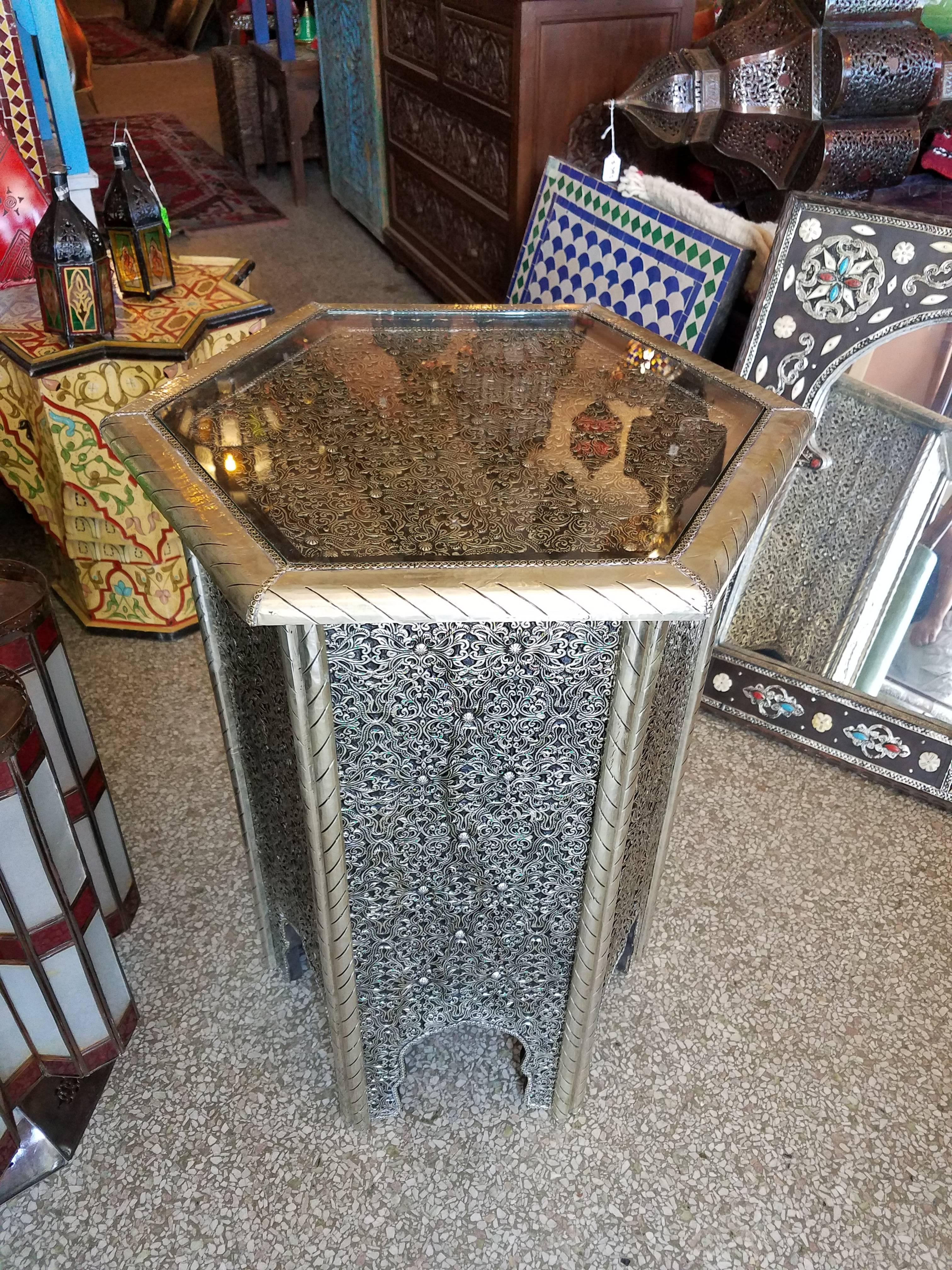 Very exotic all metal inlaid Moroccan side table. With its detailed carving along the sides and the top, this side table will sure be a excellent add-on to your décor. It measures approximately 28” in height, 21