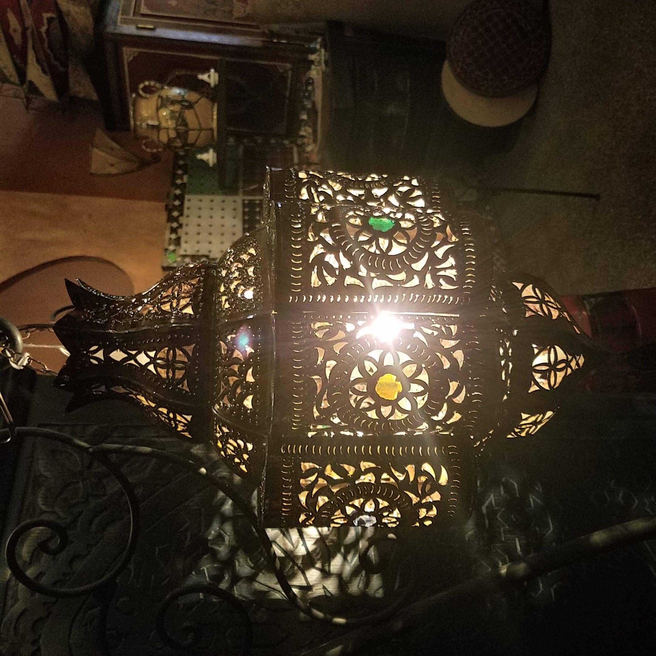Medium size Moroccan pierced metal lantern, Bal style with small multi-color glass fragments on a copper stained frame, measuring approximately 22? in height and 11