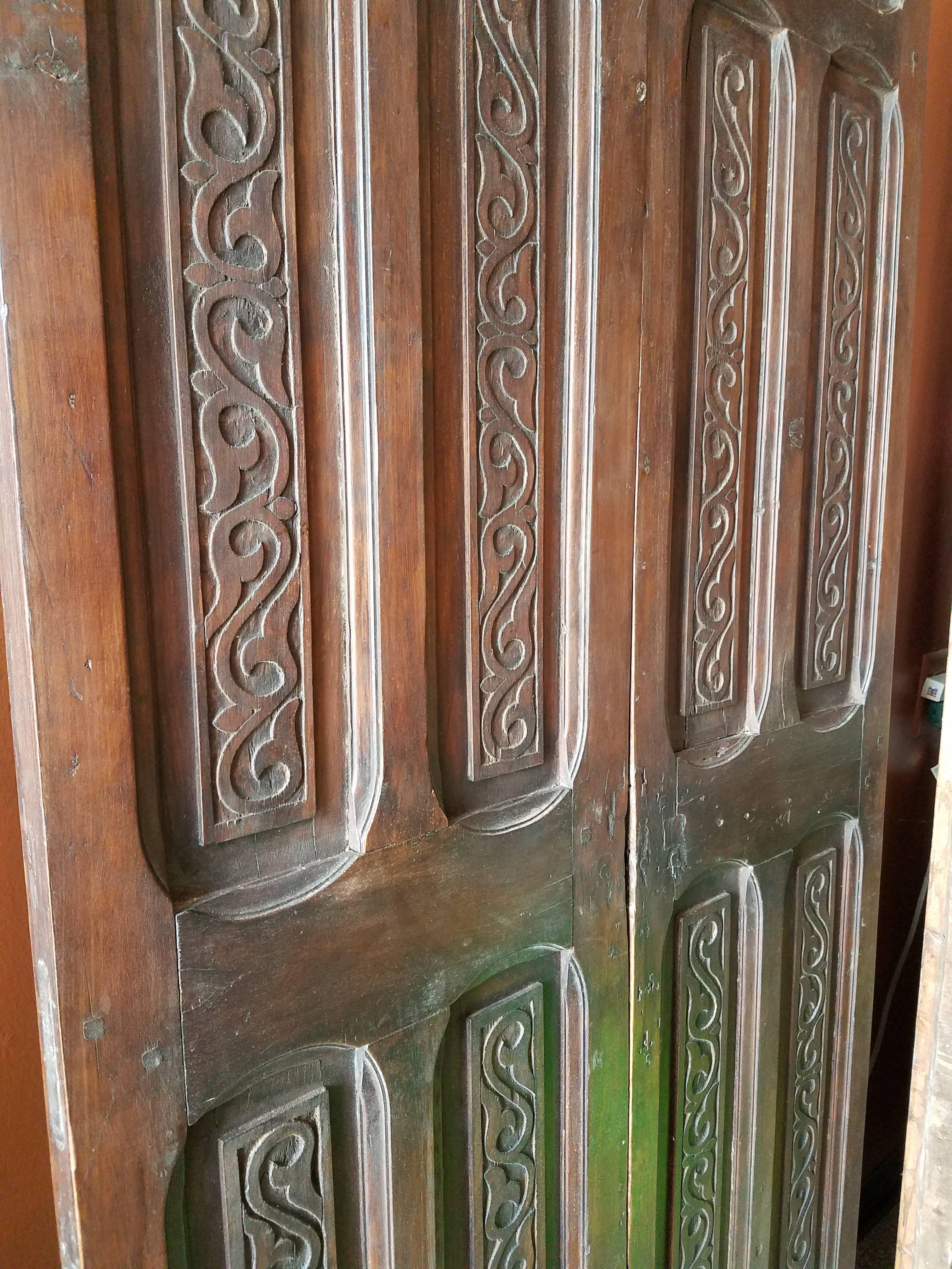 Old Early 1900s Moroccan Wooden Door, Mediterranean Scroll Motifs In Fair Condition For Sale In Orlando, FL
