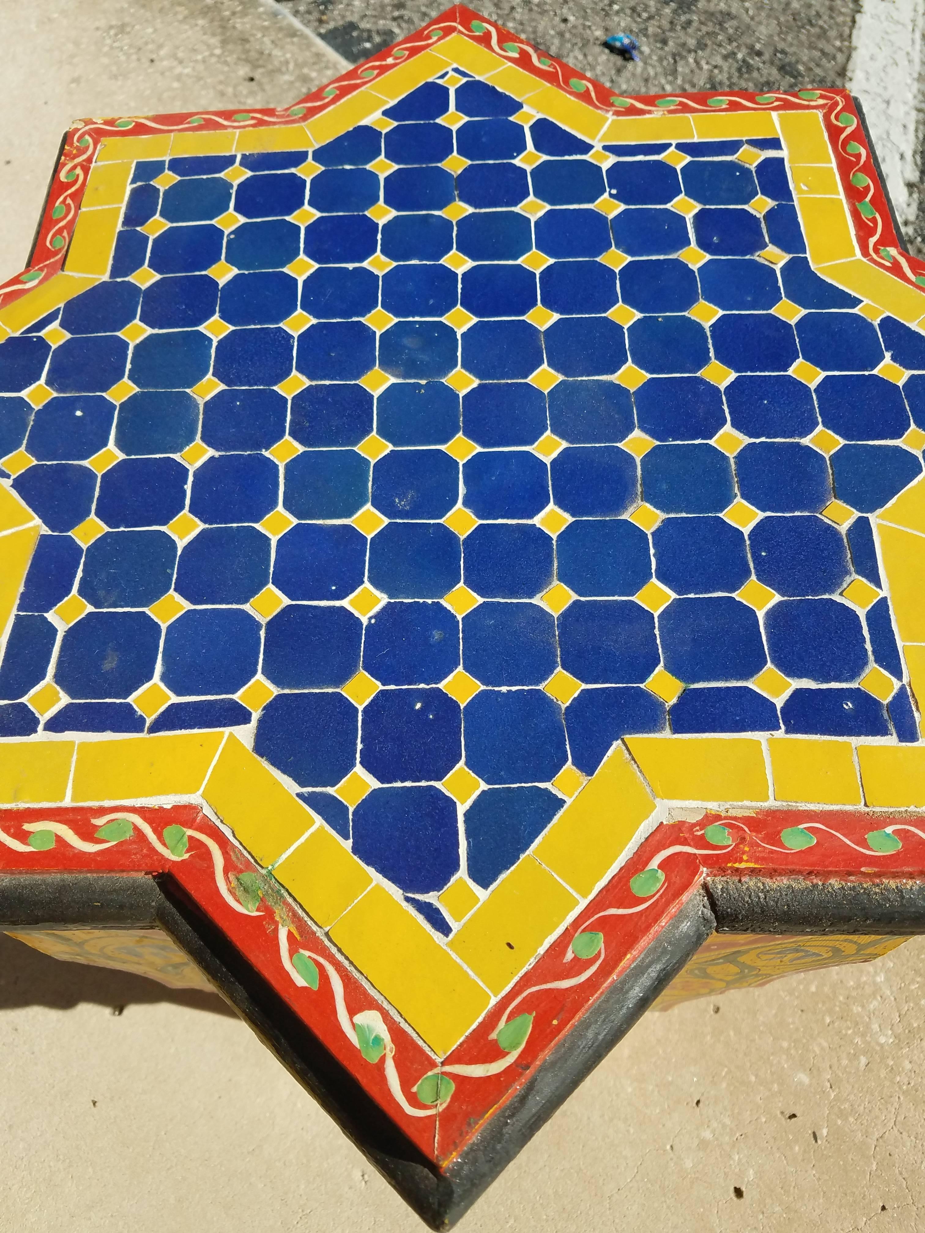 Rare find! Carved and 100% hand-painted Moroccan star shape side table. But this one has beautiful tile work on top, instead of the usual piece of glass. Amazing handcraftsmanship. Beautiful add-on to your Decor. This table measures approximately
