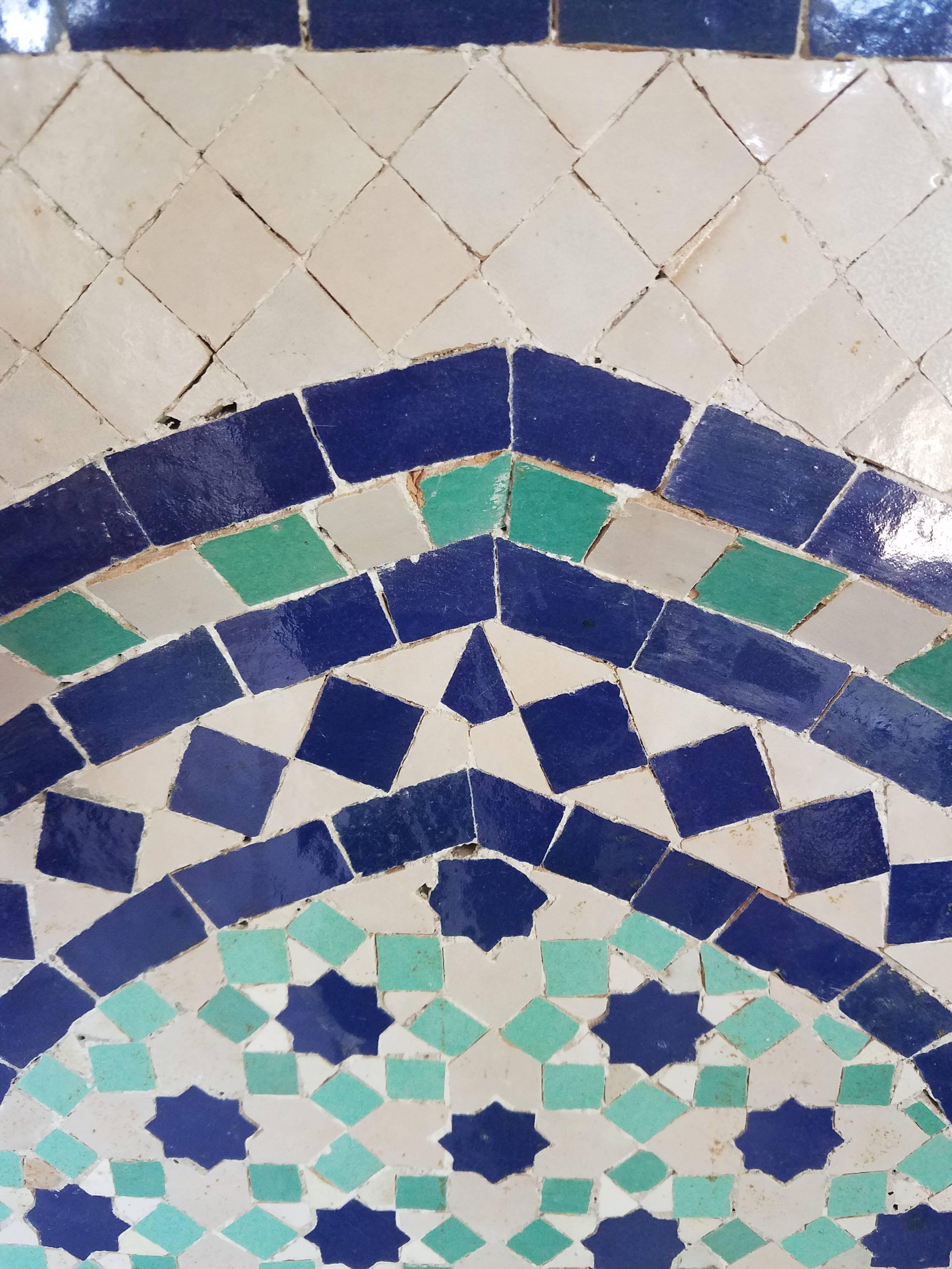Multicolored tile fountain with aqua, white, and blue color tiles handmade in Marrakech, Morocco. This beautiful fountain measures approximately 40 in height and 24 in width and weighs about 180 lbs. It comes with a copper spout (as shown in