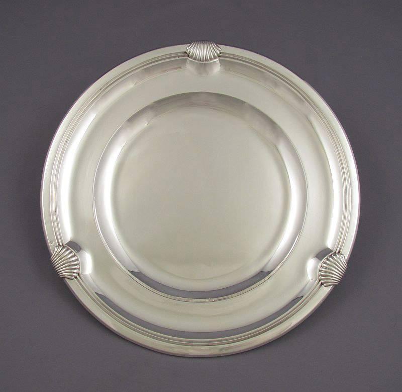 A pair of fine quality handmade French. 950 silver charger plates by Boin Taburet, Paris, circa 1920. Circular with molded edge and stylized scallop shells. Measures: 13" (33cm), 71.2 ozt (2213g).