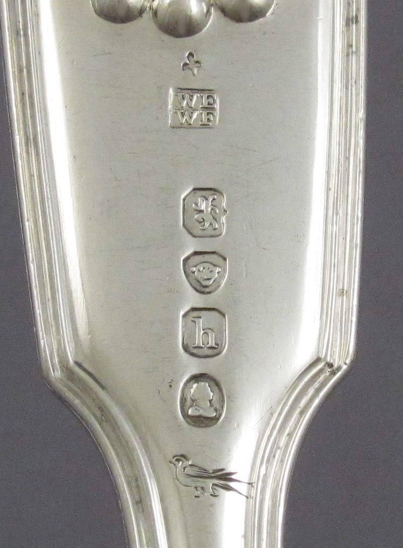 A fine quality antique George IV sterling silver flatware service for 18, London, 1823 and other dates, predominantly by William Eley and William Fearn. Fiddle Thread & Shell pattern, engraved with two family crests both for Taylor-Smith.

18