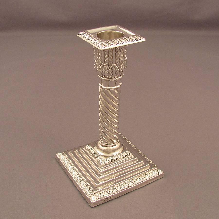 A set of four sterling silver candlesticks hallmarked Sheffield 1895 by William Gibson and John Langman. Spiral columns on stepped bases, 5 7/8" (15cm) high, 3 1/4" (8.5cm) across at the base.