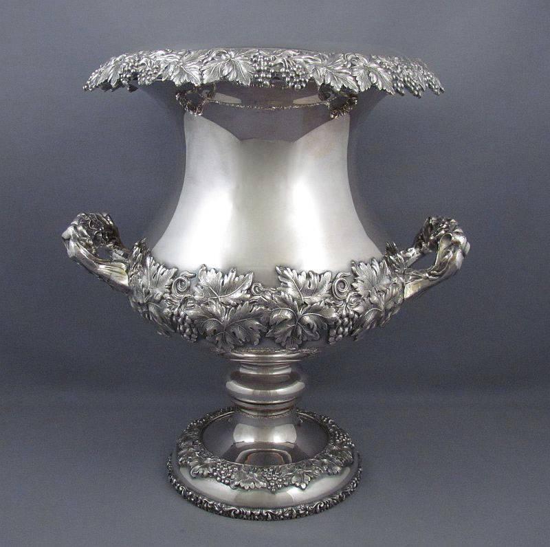 A pair of fine quality antique silver plate wine coolers, Sheffield circa 1830, campana shaped with applied grape and vine decoration, 13