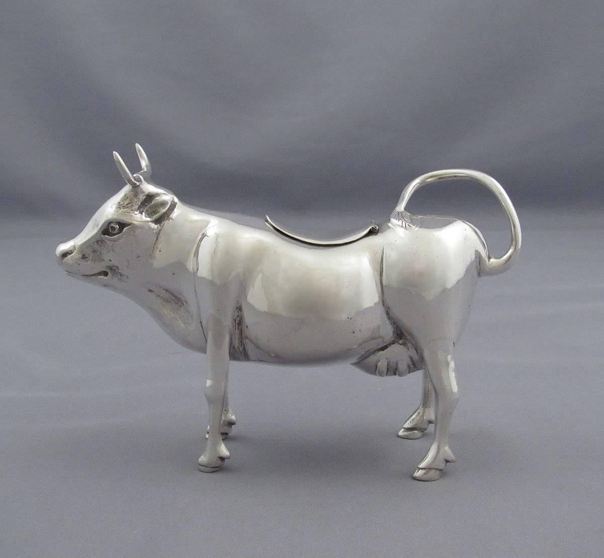 An Italian silver cow creamer (800 standard) by Giulio Coppini, Florence, circa 1930. Realistically modeled, with a hinged lid on the back, 5