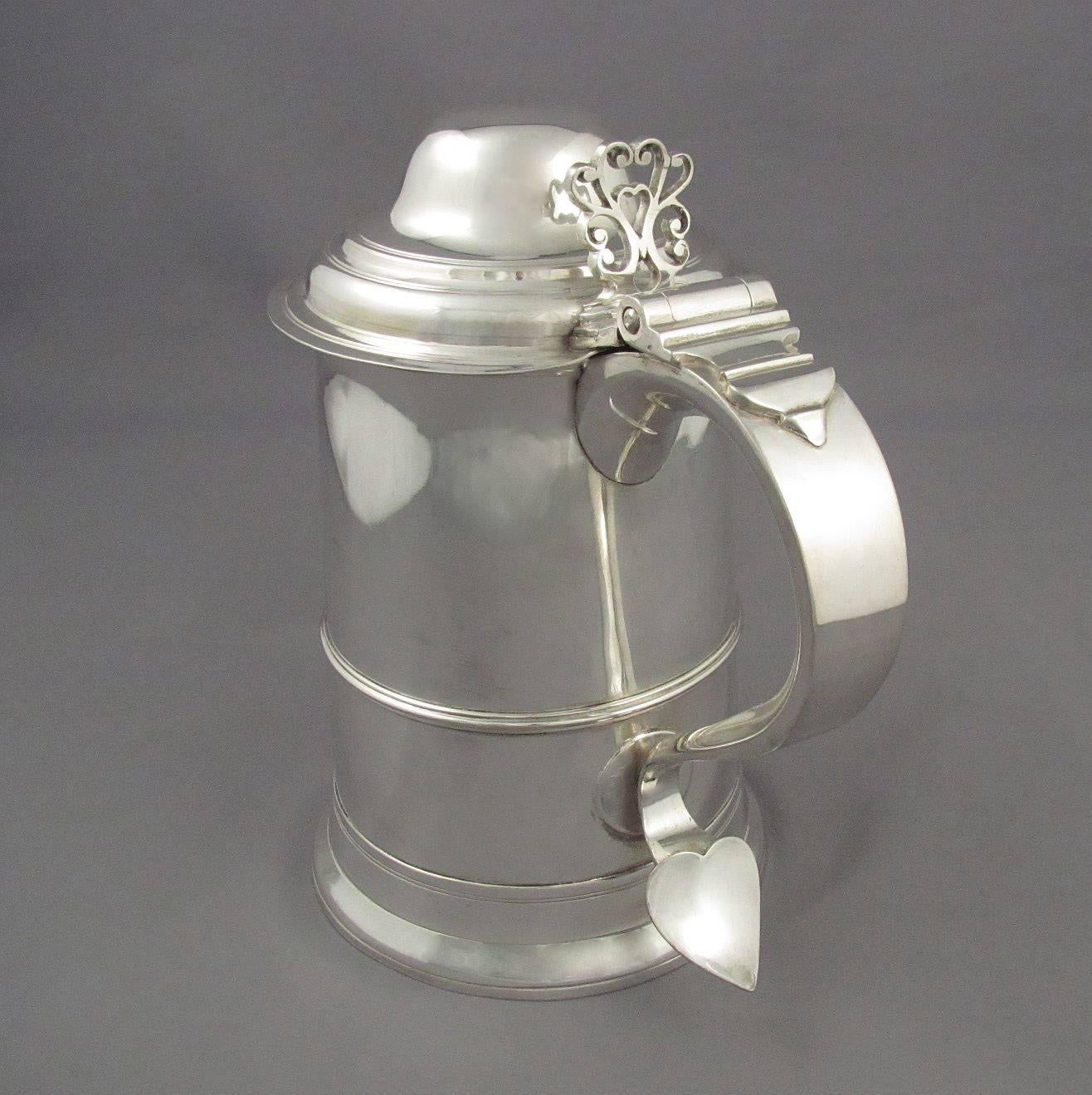 George III sterling silver tankard by Samuel Godbehere & Edward Wigan, London, 1791. Straight sided with domed lid and scroll handle. Measures: 7.5" (19.1cm) high, 22 troy ounces (683.9g).