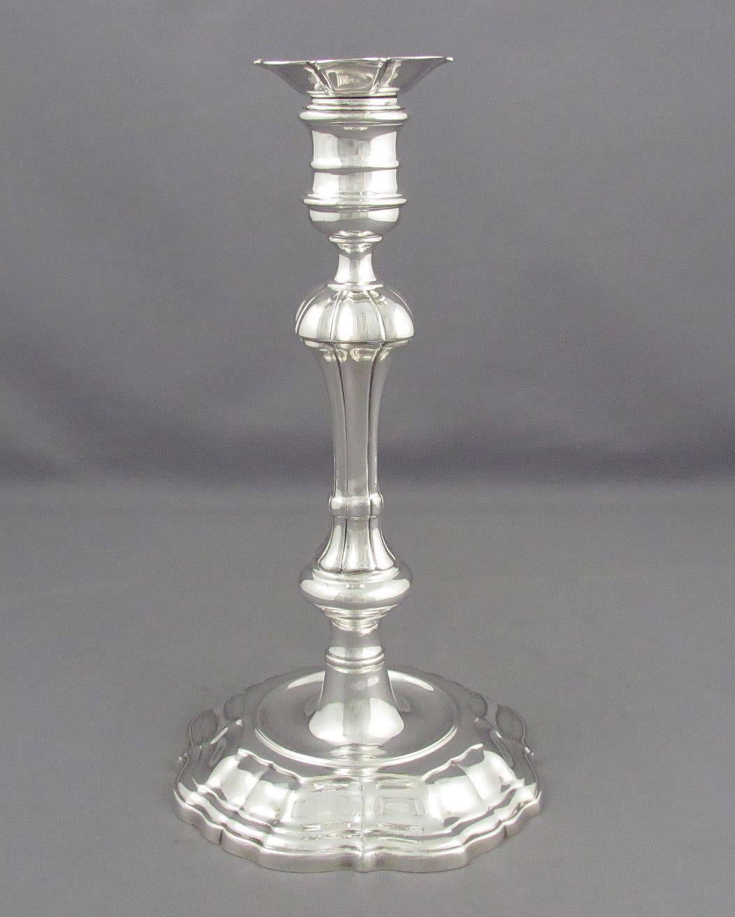 A set of four sterling silver candlesticks by Tiffany & Co., New York 1947-1956. In the George II style, after originals by David Willaume, Fine quality cast construction, removable nozzles. 9" (23cm) high, 63.4 ozt (1971g).