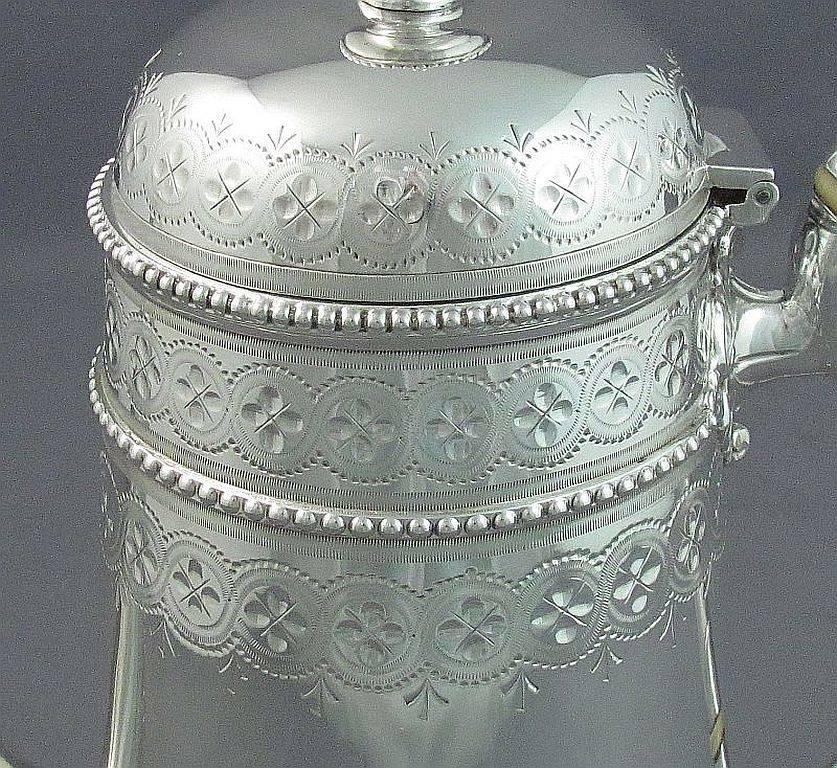 A four-piece Victorian sterling silver tea service by Joseph & Edward Bradbury, hallmarked for London 1872. Tapered cylindrical shape with pretty hand engraved decoration and bead borders. Engraved with a monogram T, stamped with a design