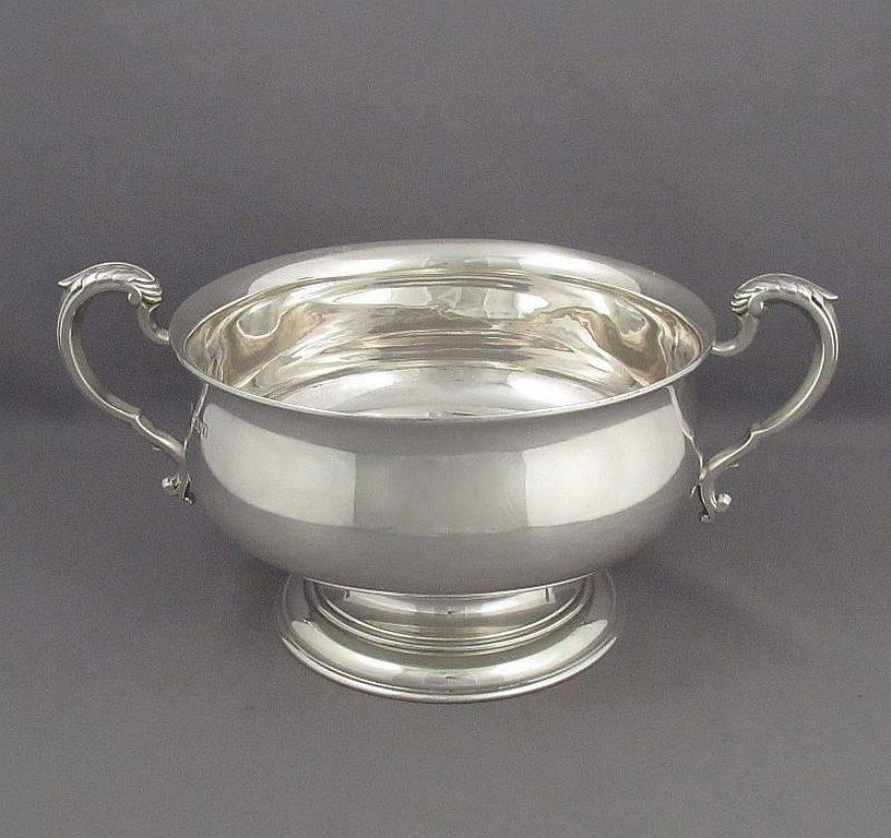 An Edwardian sterling silver rose bowl by Mappin & Webb, hallmarked London, 1906. Circular shape on pedestal foot with two double-scroll handles, 10.5