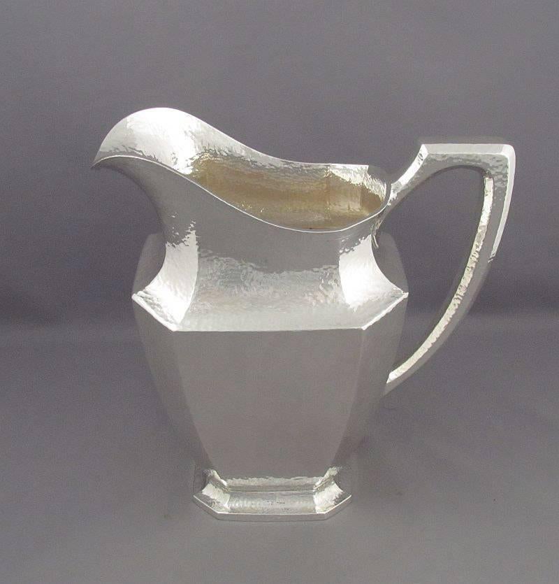 American sterling silver water pitcher (or water jug) by R. Wallace & Sons, Wallinford, Connecticut, circa 1920. Tapered rectangular form with canted corners and hammered finish, 9.25