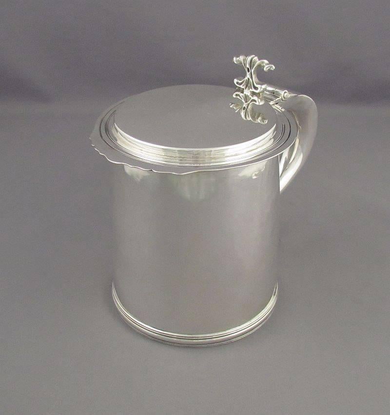 An English sterling silver tankard in the Charles II style by Crichton & Co, London 1934. Cylindrical shape with flat lid and double scroll handle, 6.25