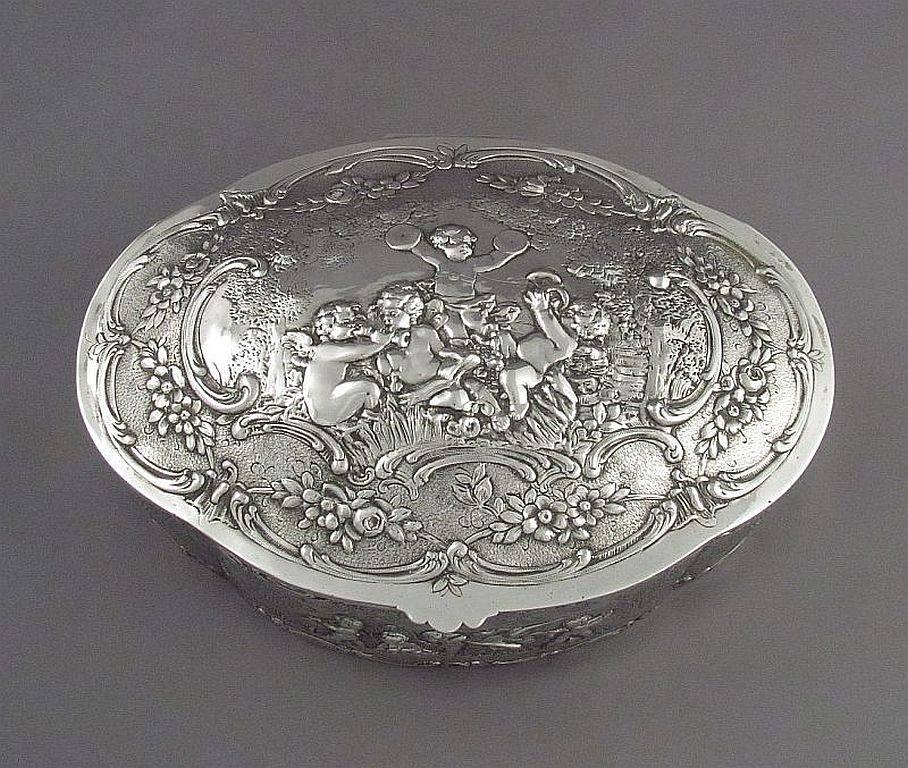 A massive fine quality German .800 silver jewellery box by Wilhelm Weinranck, Hanau, circa 1890. The domed lid, front, back and sides embossed and chased in high relief with cherubs, scrolls and foliage. Measures: 10.25