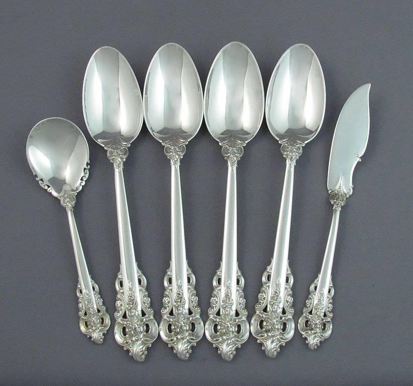 An extensive Wallace Grande Baroque sterling flatware service for 12 comprising:

12 dinner knives
12 dinner forks
12 luncheon knives
12 luncheon forks
12 butter spreaders
12 salad forks
12 dessert spoons
12 large teaspoons
12 small