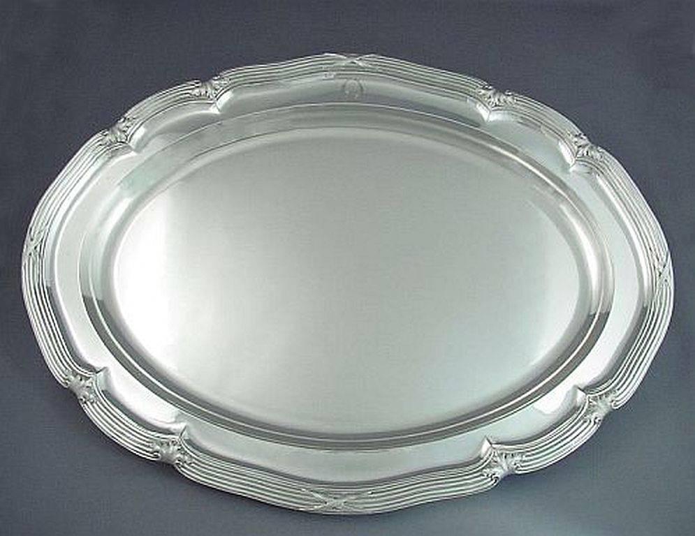 A fine quality early Victorian sterling silver meat platter by renowned makers John Mortimer & John Samuel Hunt, hallmarked London 1843.  Handmade, shaped oval form with applied reed and ribbon borders and handle.  Engraved with a family crest. 