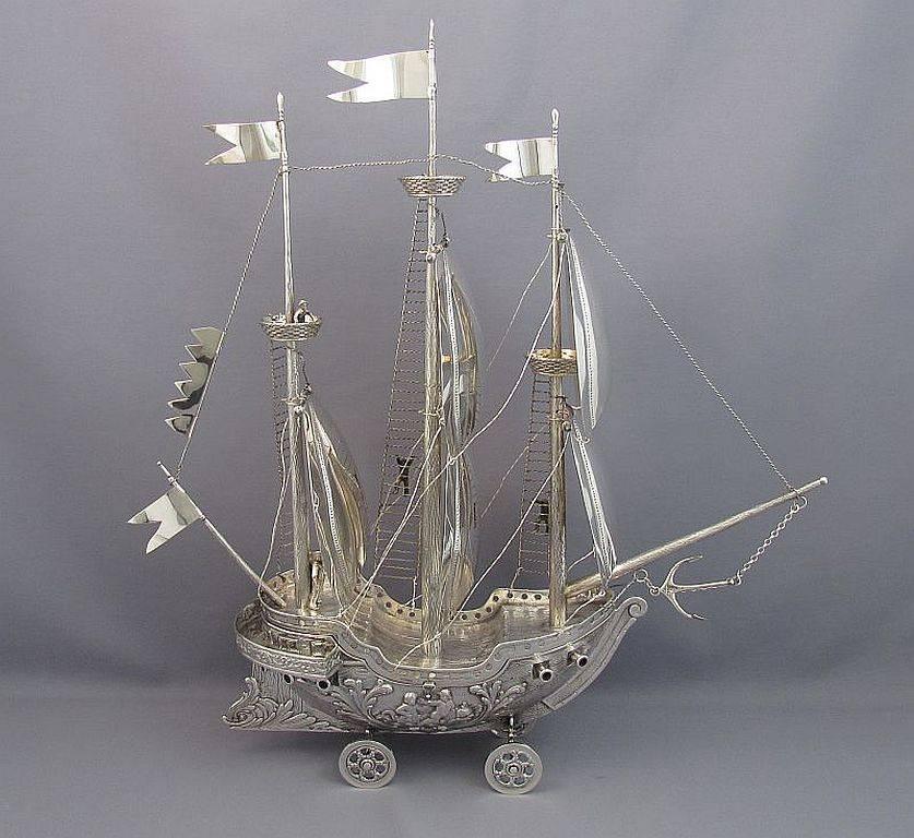 A superb sterling silver model of a galleon, Spanish, circa 1930. Intricately detailed with three masts with multi section sails, crows nests, flags, rigging, cannon and figures of sailors. The hull is finely chased with wood grain and embossed with