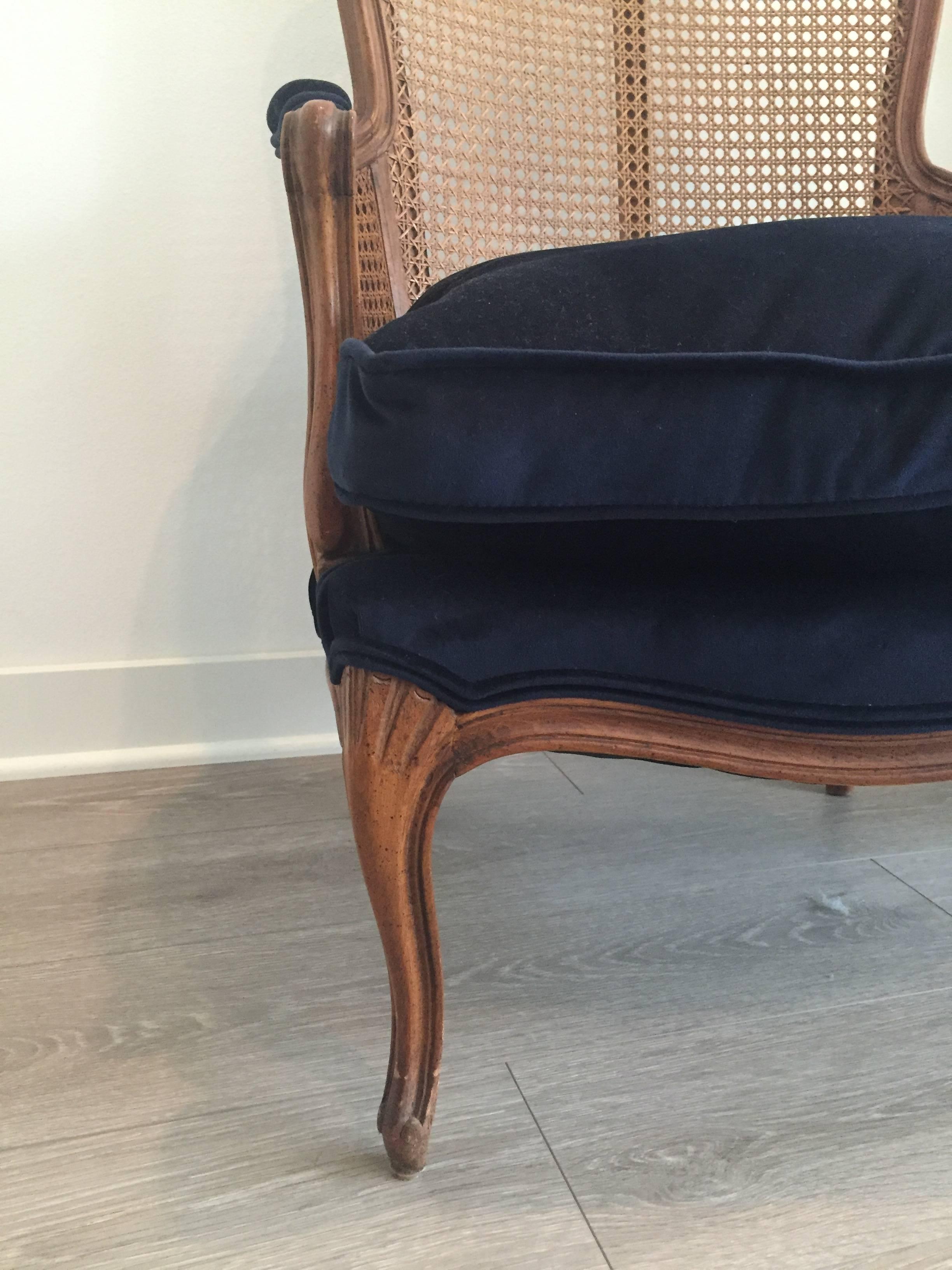 Caneback French Bergere in excellent condition. Seat and cushion have been newly upholstered in a lush midnight blue velvet. Down insert with zipper enclosure.