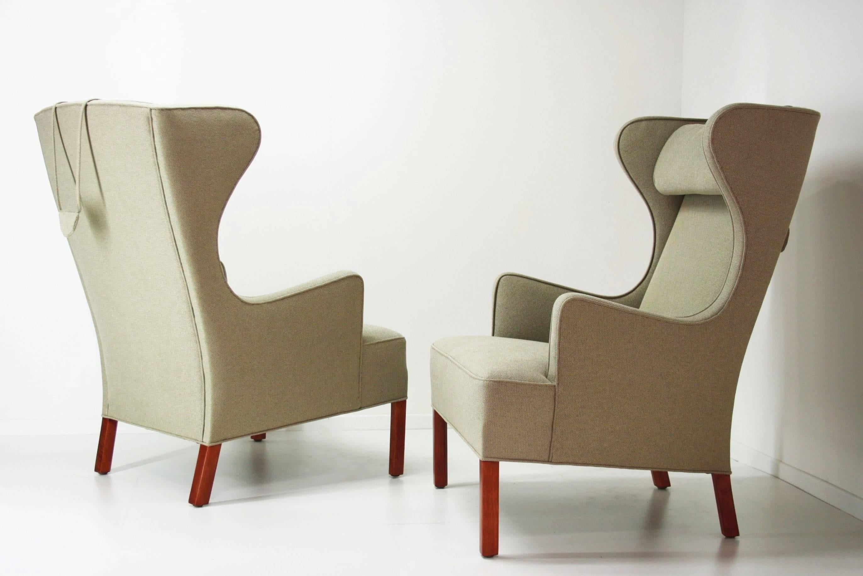 A very rare pair of wing chairs designed by Hans Wegner in 1945 and manufactured by Johannes Hansen.
This design dates from his early period and was only made in a limited edition. 
These chairs have been completely restored and reupholstered with a