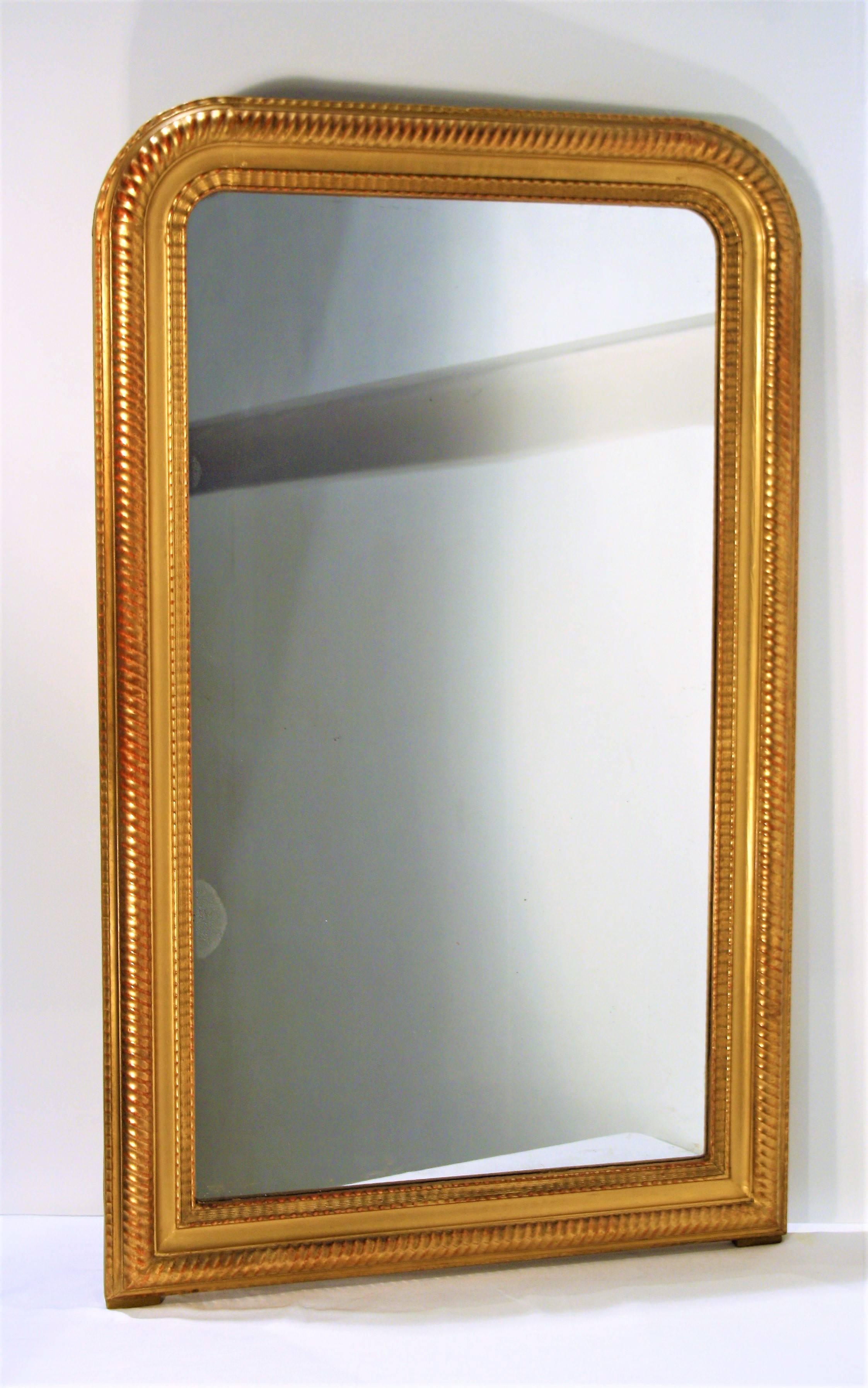 A very rare French mid-19th century Louis Philippe period mirror in giltwood. Patterns inspired from bamboo with its original mercury glass and its original wooden back.
 