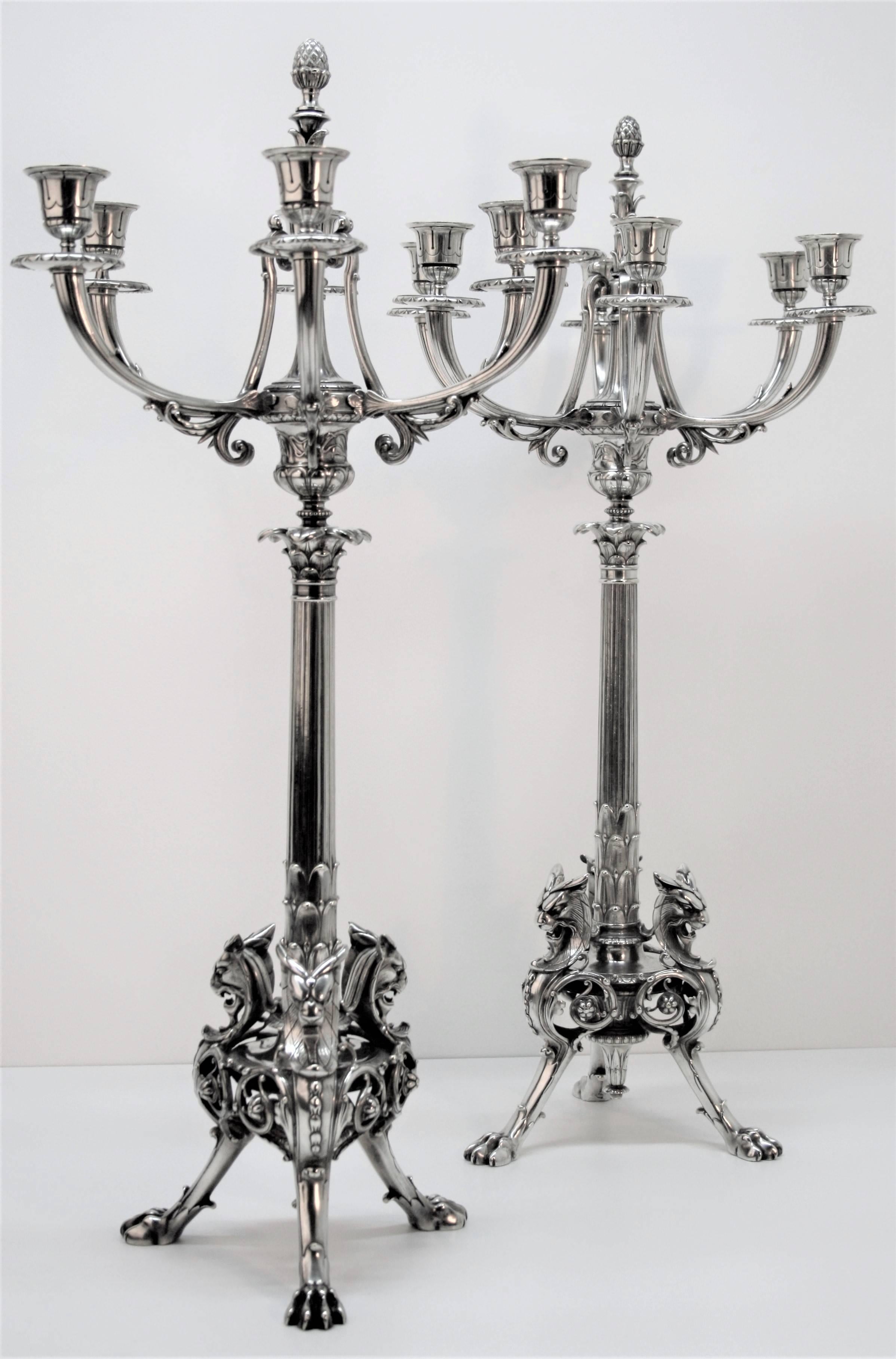 An exceptional and impressive pair of candelabra from the Parisian goldsmith Christofle. Finely chiseled and executed by Charles Christofle in the late 19th century, mounted on 3 feet of Griffins, fluted shaft adorned with acanthus leaves, Medicis