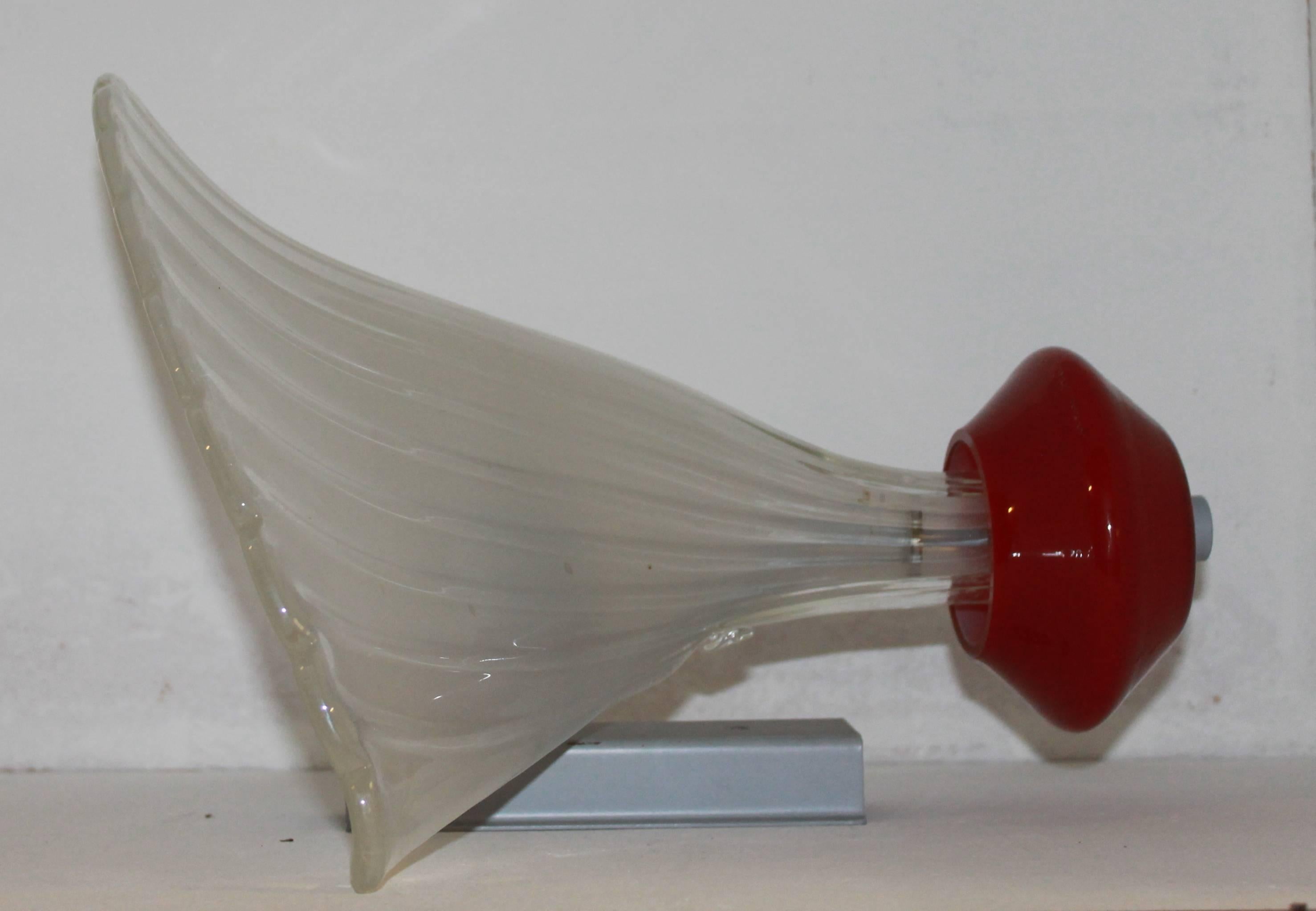 Bubble Glass by Paolo Venini, dated 1920 circa.

The sconce has glazed clear white ubble glass and a red glass base. The support is in nickeled metal.