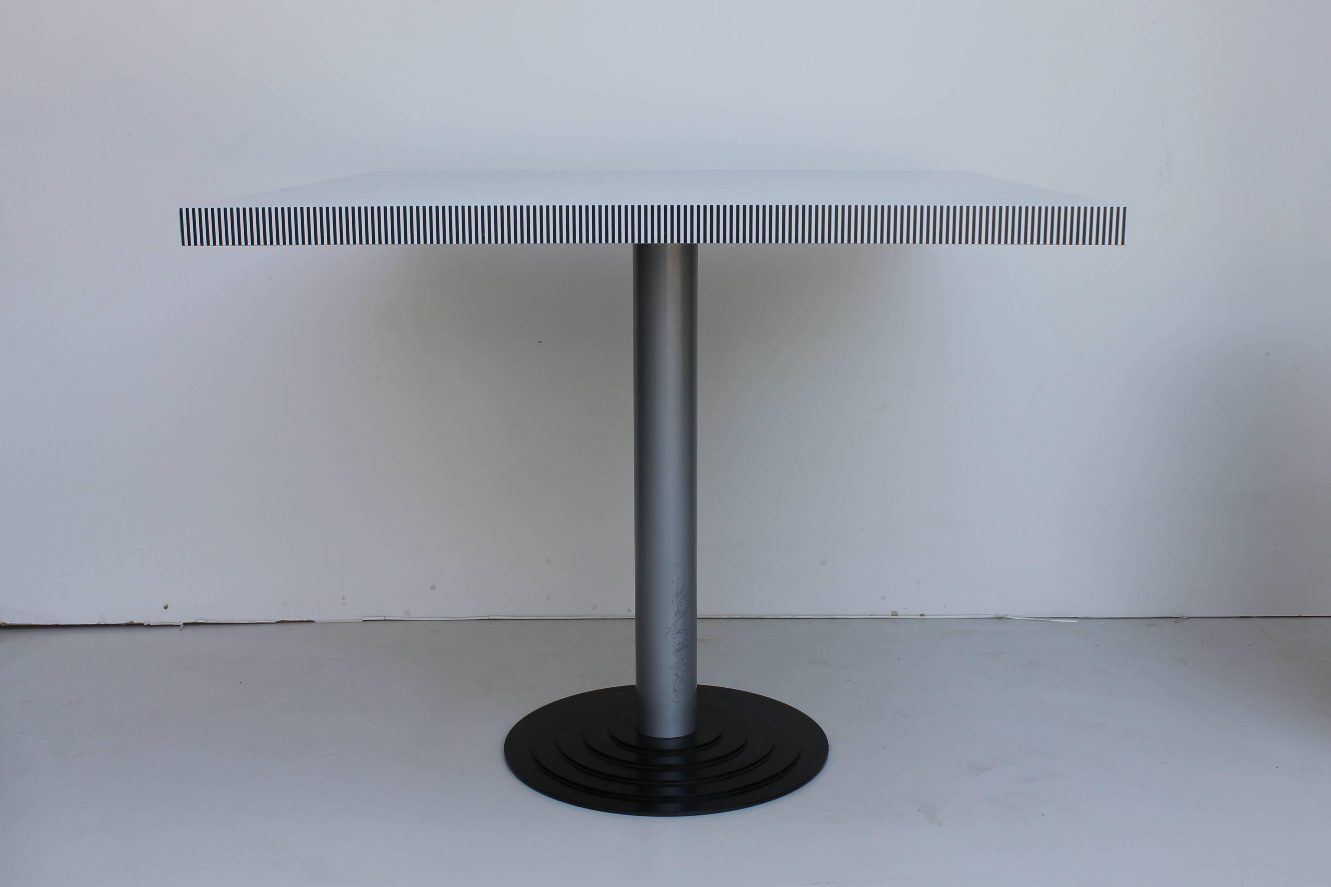 A striking and rare dining table produced by Driade, the company which Astori co-founded in 1968. The table has a formica top which sits on top of a grey pedestal on a black base. A fantastic example of early Italian Postmodernism with obvious