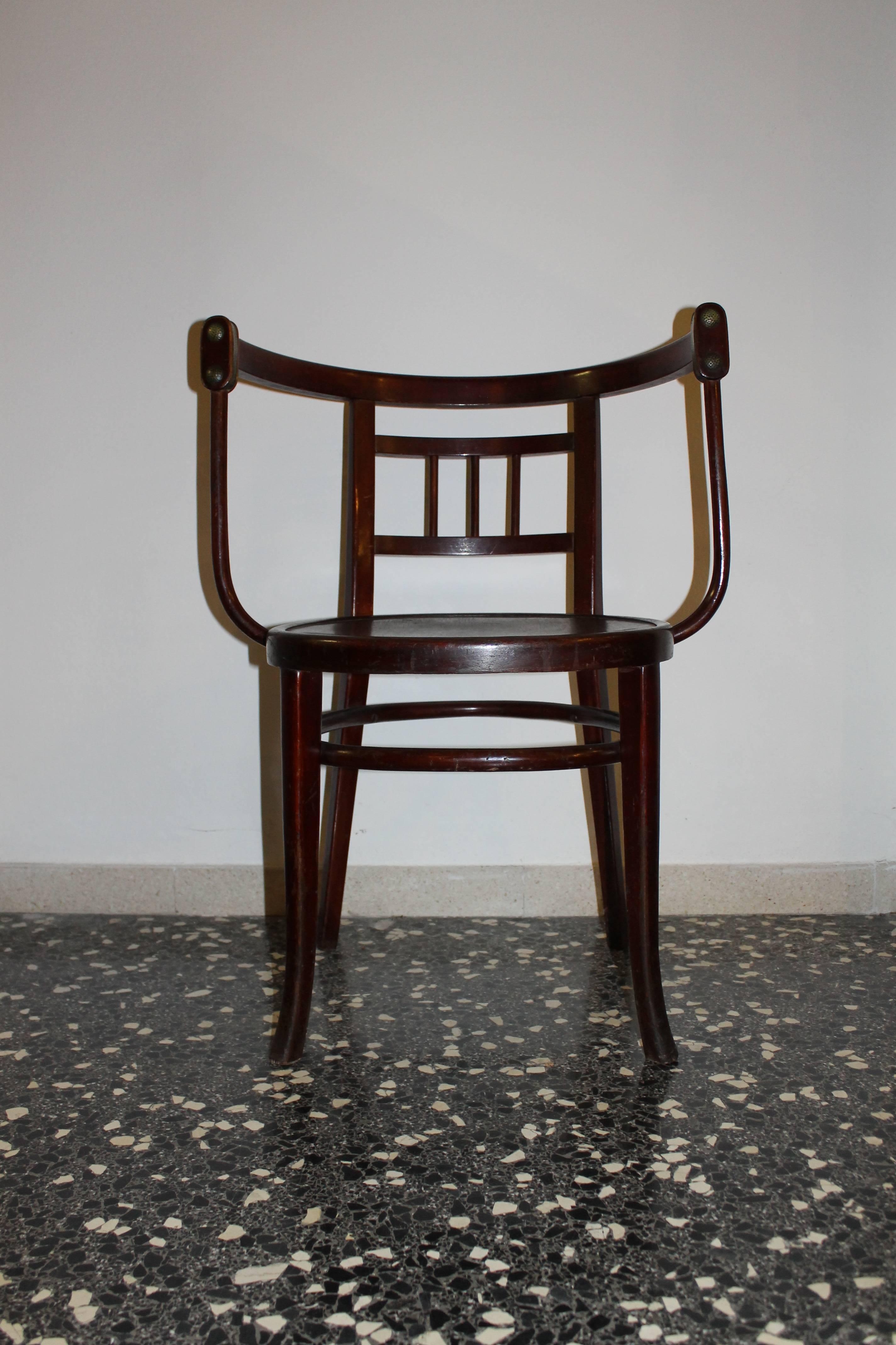 Beechwood armchair with brass buttons and details, designed by Antonio Volpe Udine, dated circa 1905.