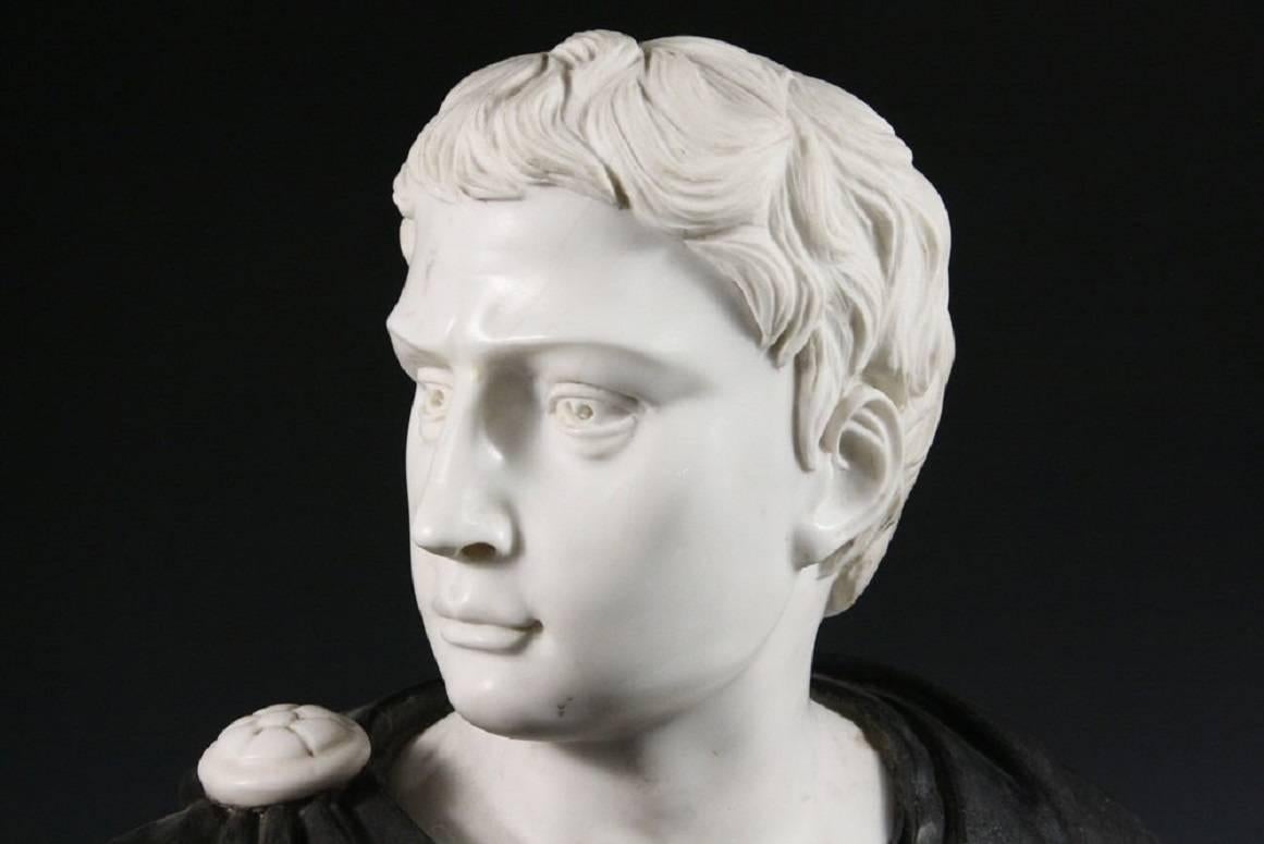 This substantial bust in striking black and white marble makes a grand impression and works well in many of today's interiors. This is believed to be a portrait of a Roman statesman, but could possibly be a depiction of Julius Ceasar. Unmarked, but