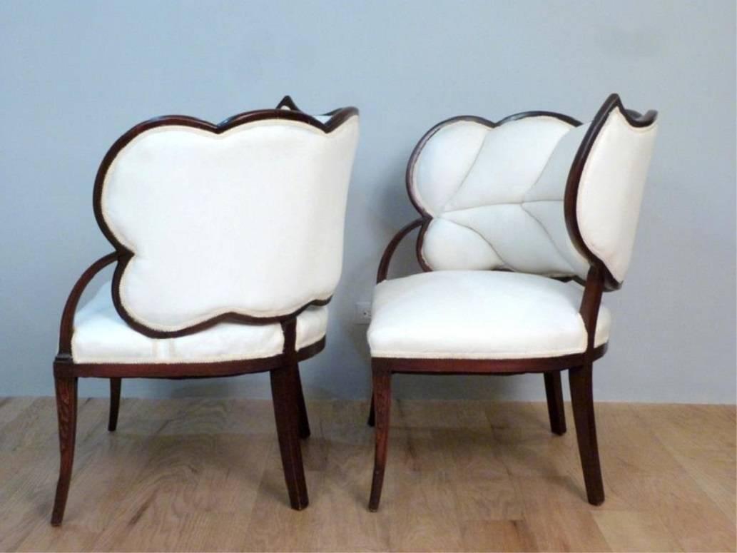 Right and left facing pair of leaf-shaped lounge chairs with beautiful carving on the front legs. Fabulous in many settings from Art Deco to Palm Beach / tropical style. The moderate size of these chairs also ensures that they will fit into a wide
