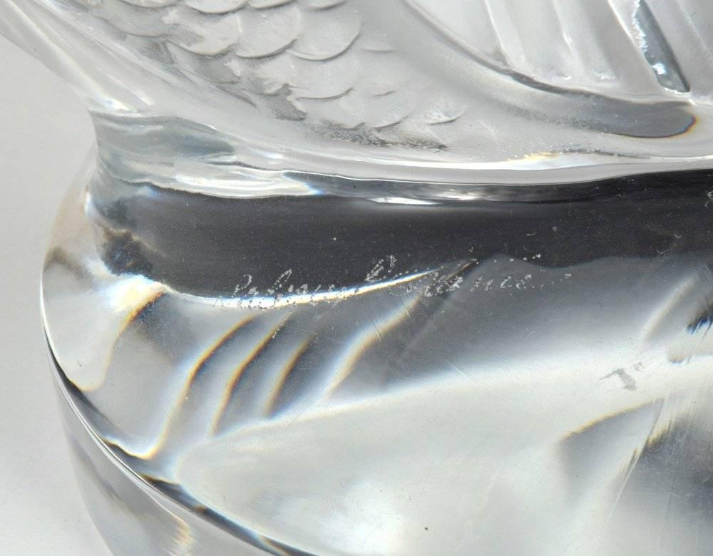 On this large satin crystal figure, originally designed in 1953 by Marc Lalique, the two fish seem to emerge from the water. Handcrafted in France. This piece is in excellent condition with no chips, cracks and only very light scratch marks on the