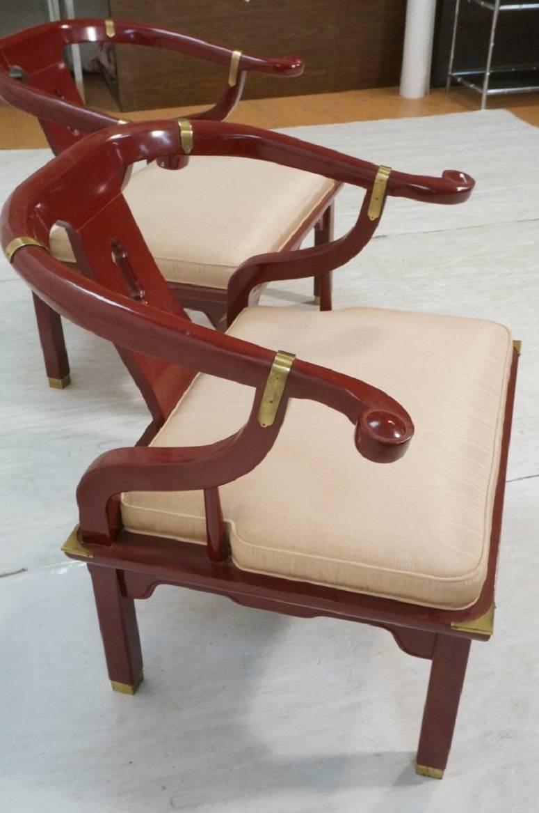 An iconic pair of 1970s horseshoe back lounge chairs by Century Chair Company. They feature a burgundy patinated finish, brass detailing and the original upholstery.

Dimensions: 29.5H x 31W x 25D