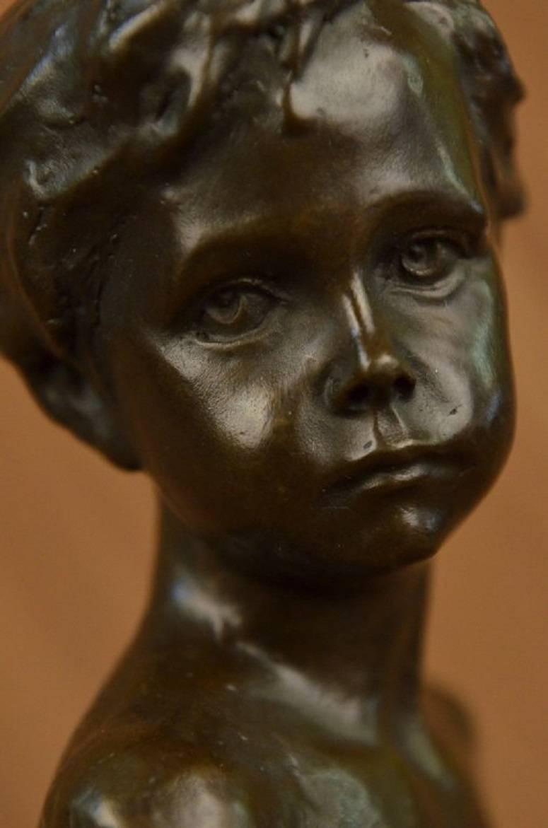 This charming bronze bust of a young boy is mounted on a marble block base. Created using the lost wax casting method for bronze. The brown patina pairs nicely with the marble select for the base. This is a perfect piece to add charm and style to