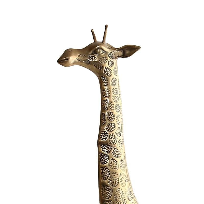 This beautifully detailed brass giraffe stands a full 4 feet tall and adds a touch of Hollywood Regency style to any space. As you can see from the up-close photos, this piece was cast in fine detail and with expert craftsmanship. The giraffe has a