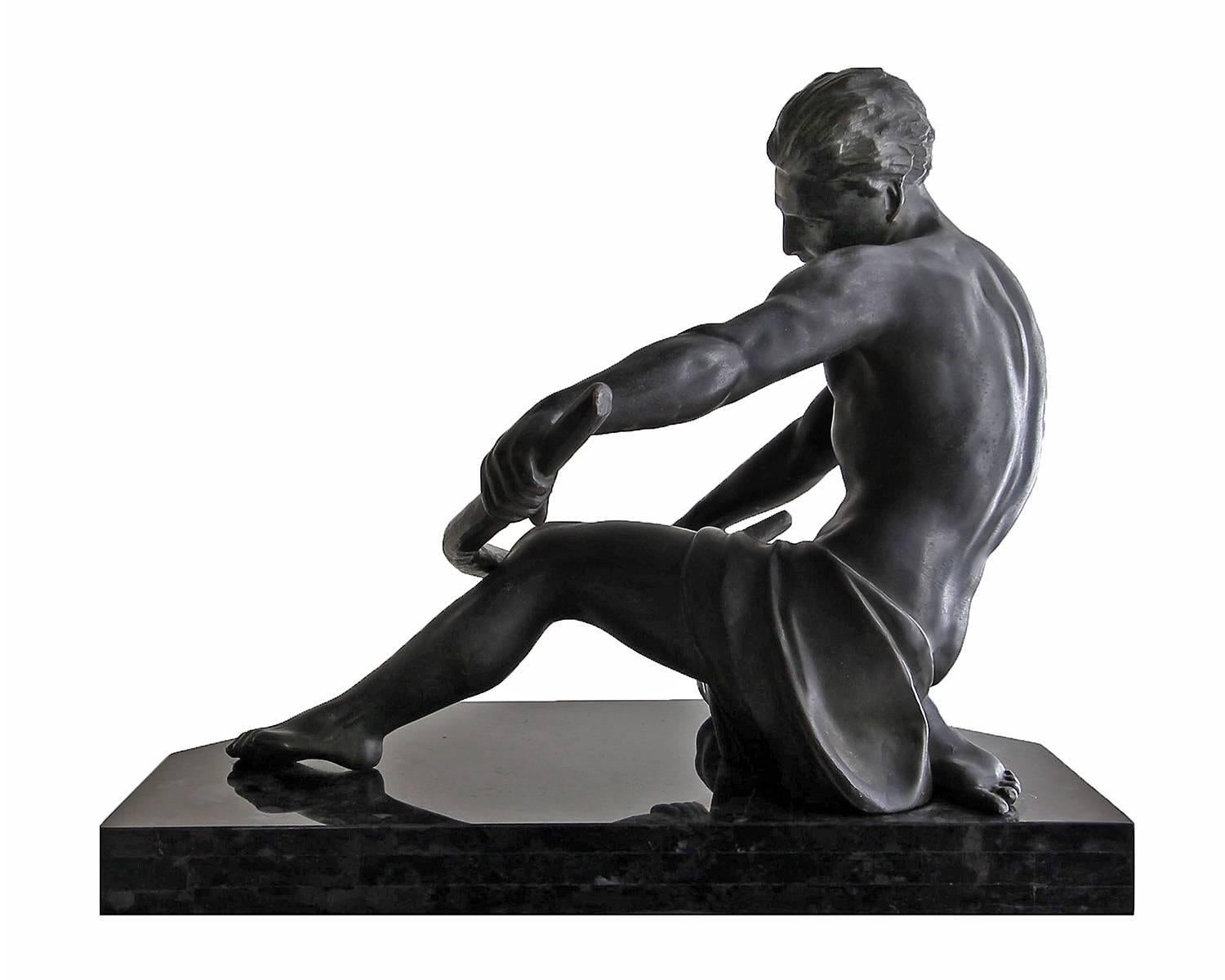 This large and impressive sculpture (21 x 18 x 15 inches) is the height of Art Deco style. It depicts a semi-nude man bending a bar over his knee. The piece has been created with an exceptional quality of casting and refinement of details. The piece